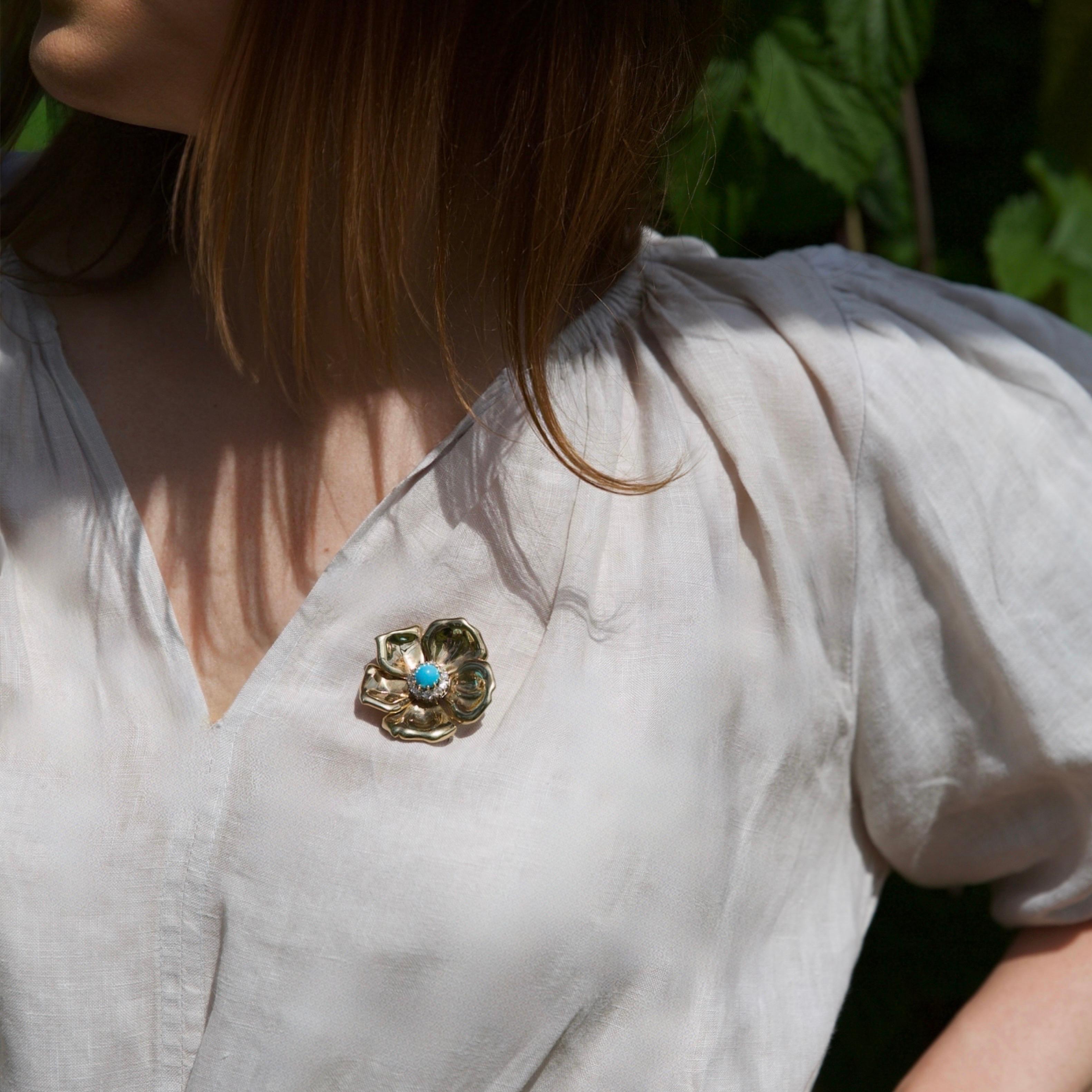 Mid-Century 9kt Gold Turquoise and Old Mine-Cut Diamond Flower Brooch.

A charming mid-century brooch in the form of a stylised flower, crafted in warm 9 karat yellow gold. The sculptural openwork petals radiate with high polish, centring on a vivid