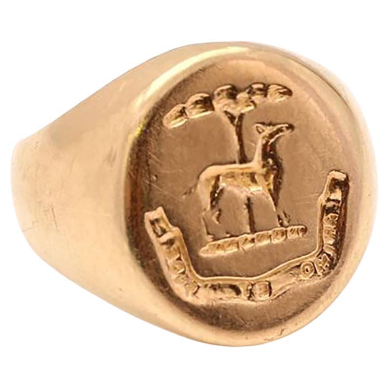 Vintage 14kt. yellow gold oval signet ring with engraved dog and Latin phrase ' Animo et fide ' .

The dog's symbolism in heraldry is faithfulness and guardianship.
Dogs were considered loyal and temperate and the dog is a symbol of a skilled