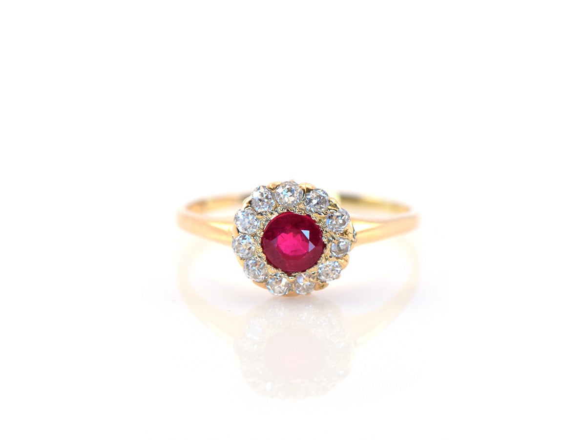 An original Tiffany ring in 14k yellow gold setting a .56ct ruby, with surrounding old mine cut diamonds.  Size 6.75