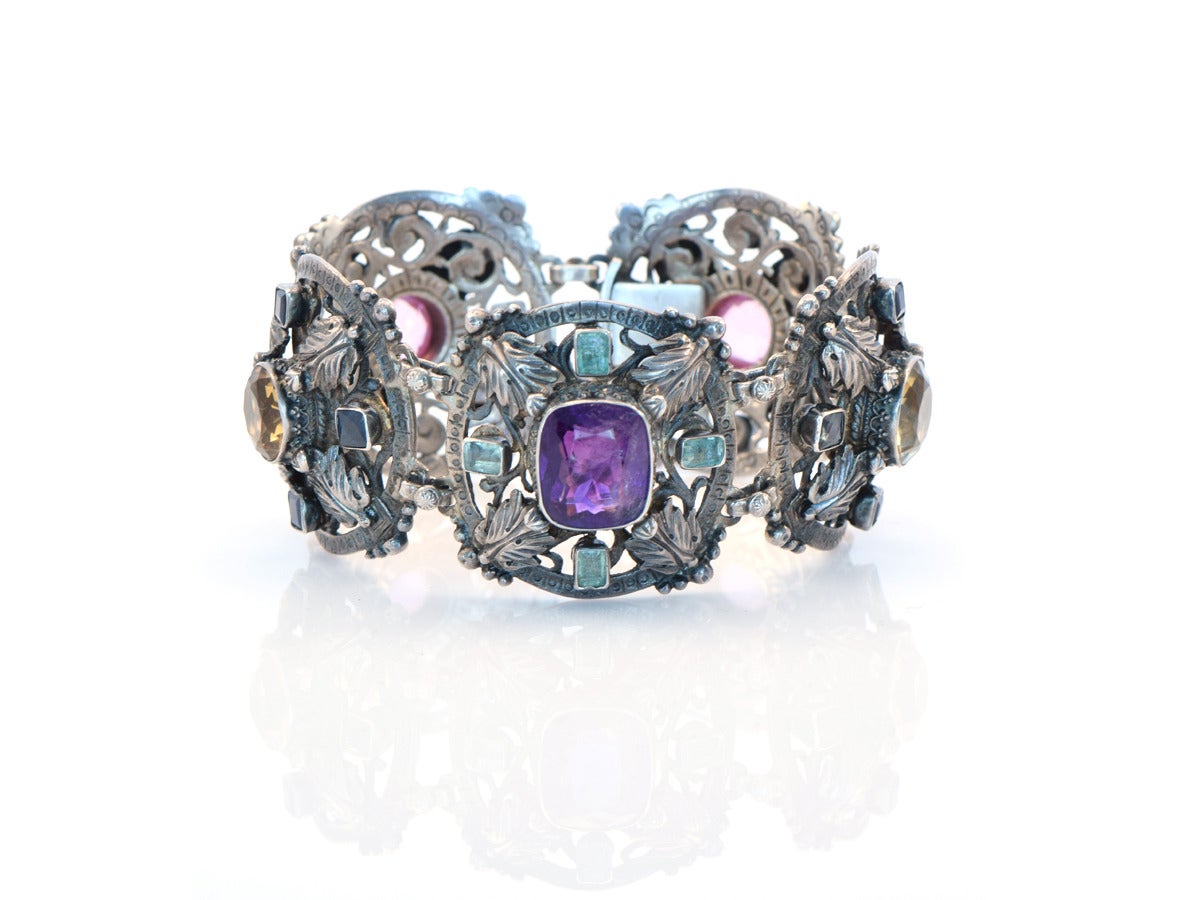 An ornate and colorful Austro-Hungarian sterling silver bracelet setting various precious and semi-precious stones.