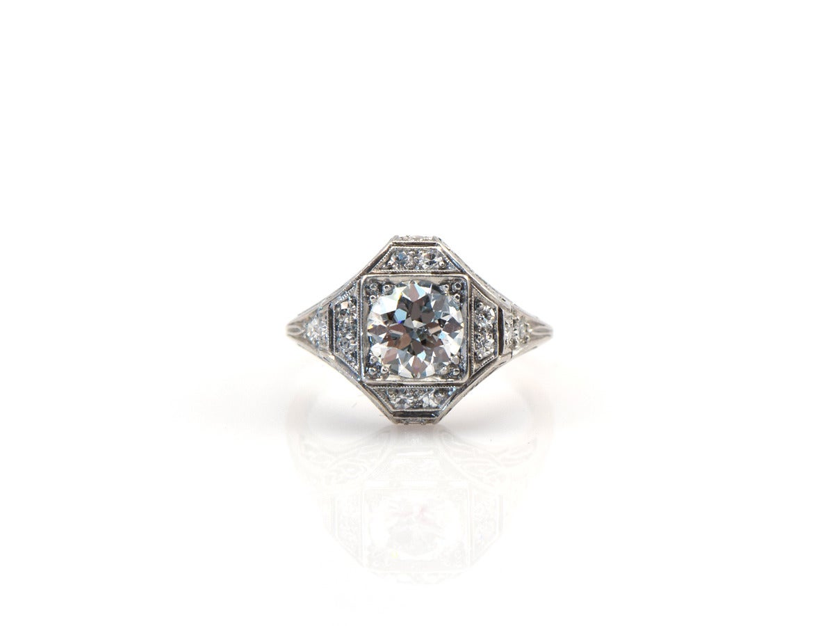 A platinum ring setting a 1.35ct antique European diamond.  Center stone is around F/G color and SI clarity. The top section measures 13mm x 13mm. There is diamond pave accentuating all along the borders, with gorgeous open filagree work on the