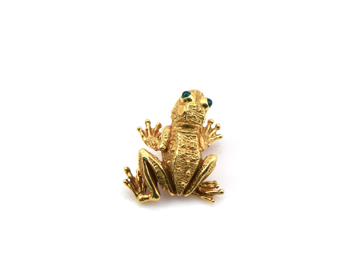 This fella keeps the best company.  The frog pin is created in 18k yellow gold and set with emerald eyes.