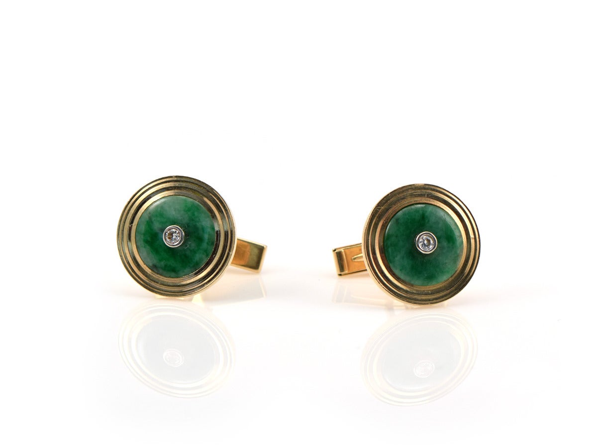 A men's pair of 14k yellow gold cufflinks, set with jade and accentuated with a white diamond.  Measures .75