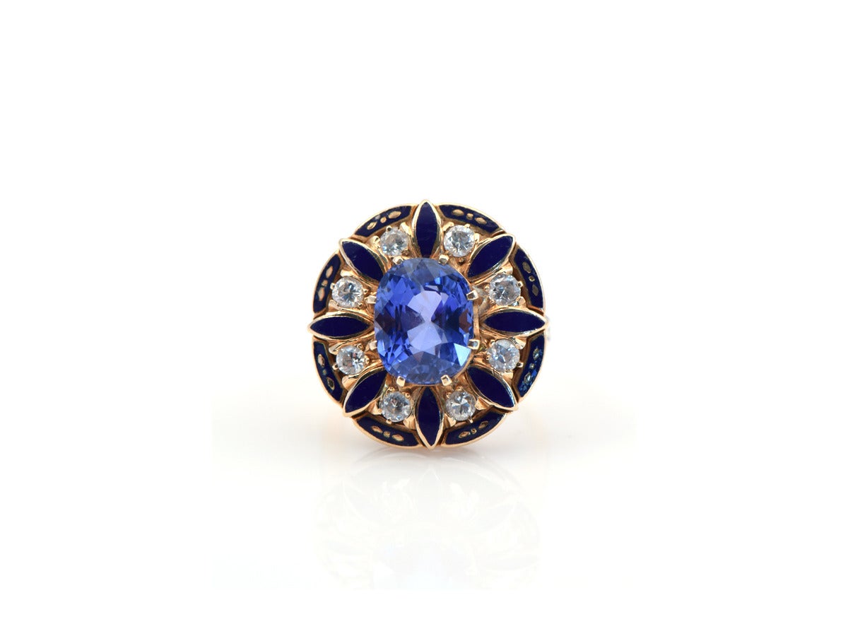 An oval shaped gold pillow of deep blue enameled petals, alternated with single cut diamonds, and setting a magnificent natural blue sapphire cushion.

*ring size 5
*natural sapphire 5.21ct
*diamond total weight is 1 ct