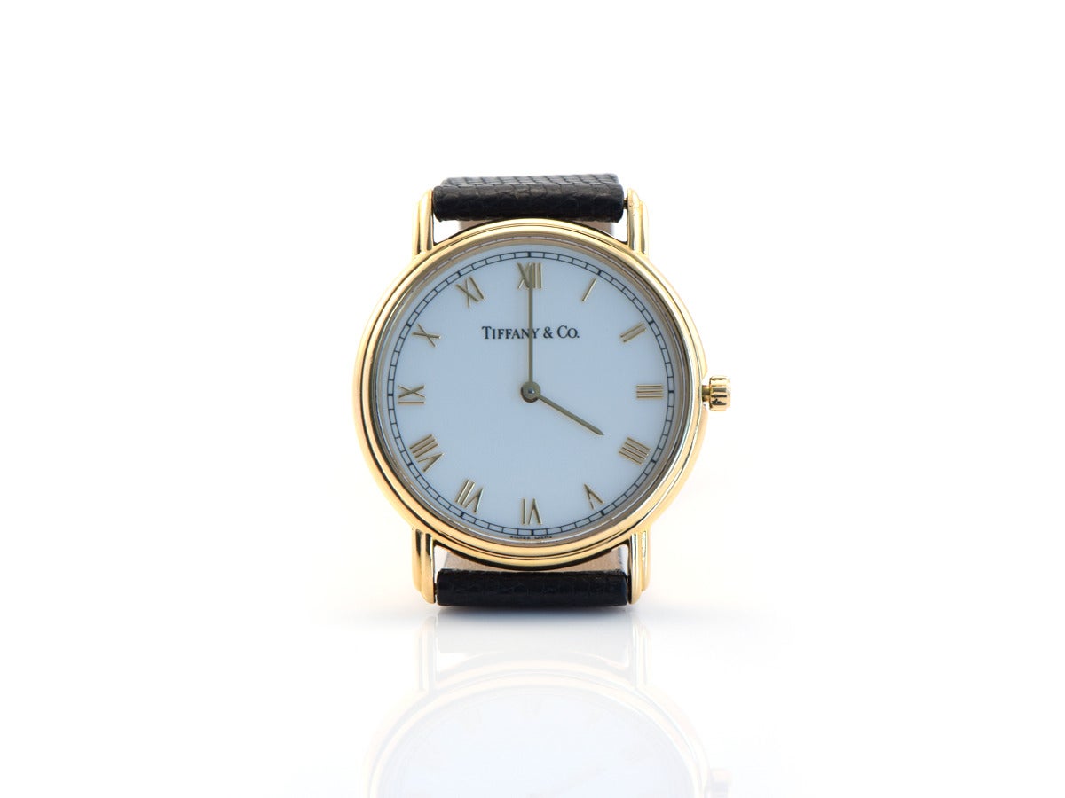 This is the ultimate classic everyday timepiece.  The Tiffany watch is created in 18k gold with a black lizard strap.