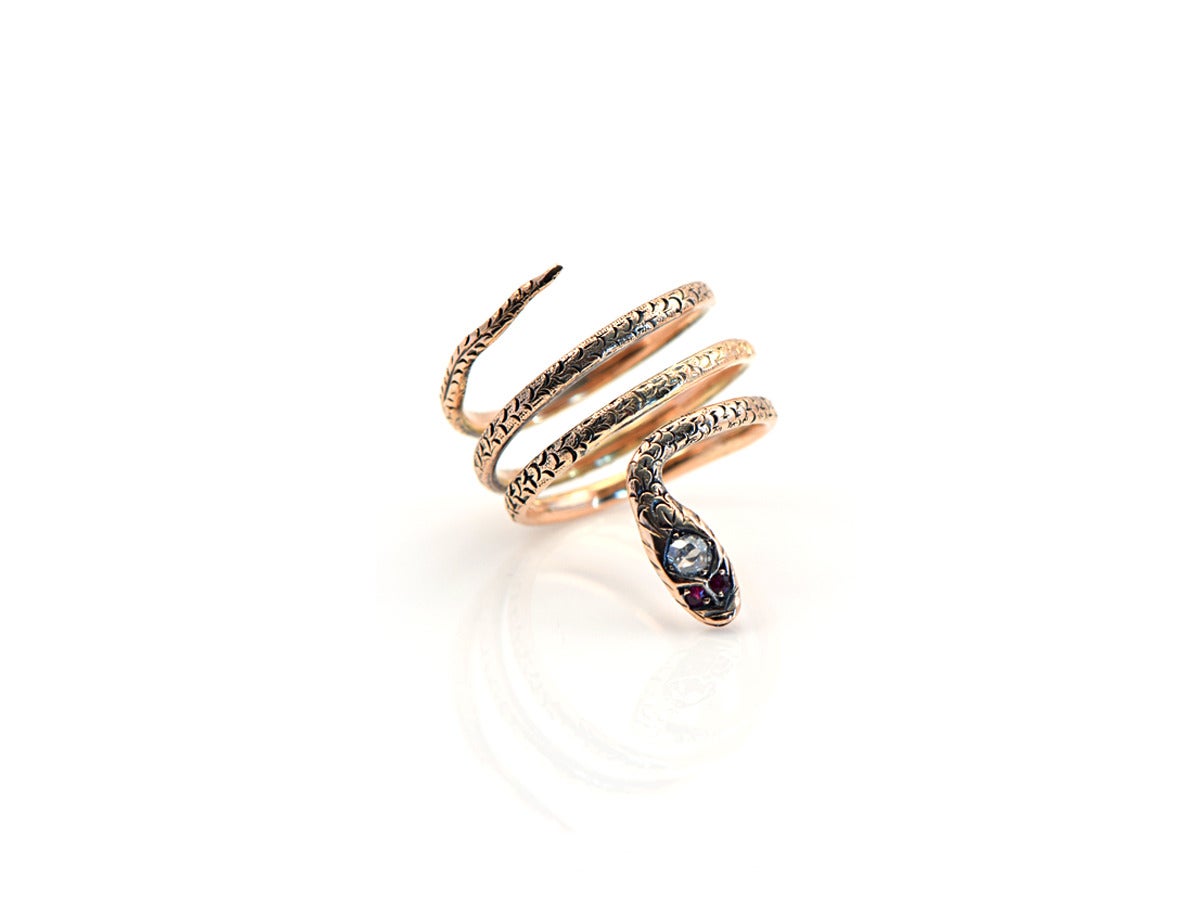 This statement ring is a 2mm wide snake and wraps around three times in14k gold.  The body is engraved and then blackened to accentuate the motif.  The ring sets low and snug to the finger. 

*Length measures slightly over 1 inch, from head to