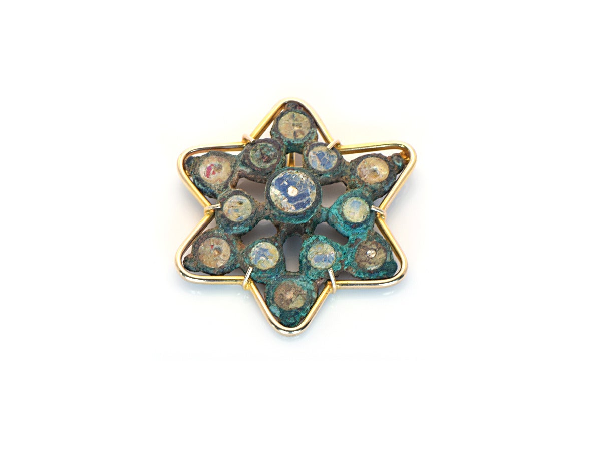 This is quite the ancient token!  The Roman glass piece has been fashioned into a 14k yellow gold brooch.  The colors of the glass and bronze have taken on their own patina and contrast beautifully with the polished gold of the custom made
