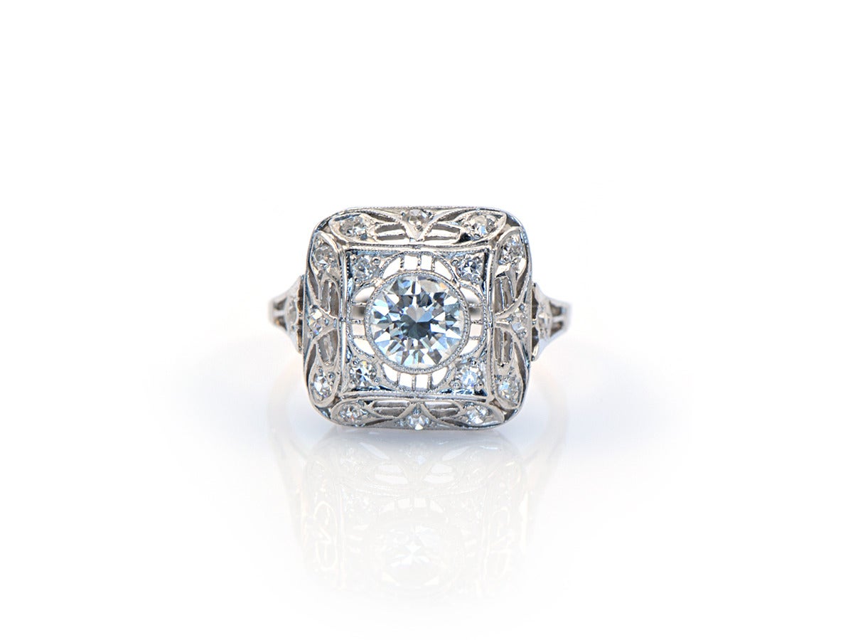 A beautifully detailed ring with open filagree, pave diamond details, and a bezel set .95ct center diamond. Milligrain finishes off the open line work. 

*platinum
*ring size 8
*.95 ct. center transitional cut diamond
*top 'pillow' measures