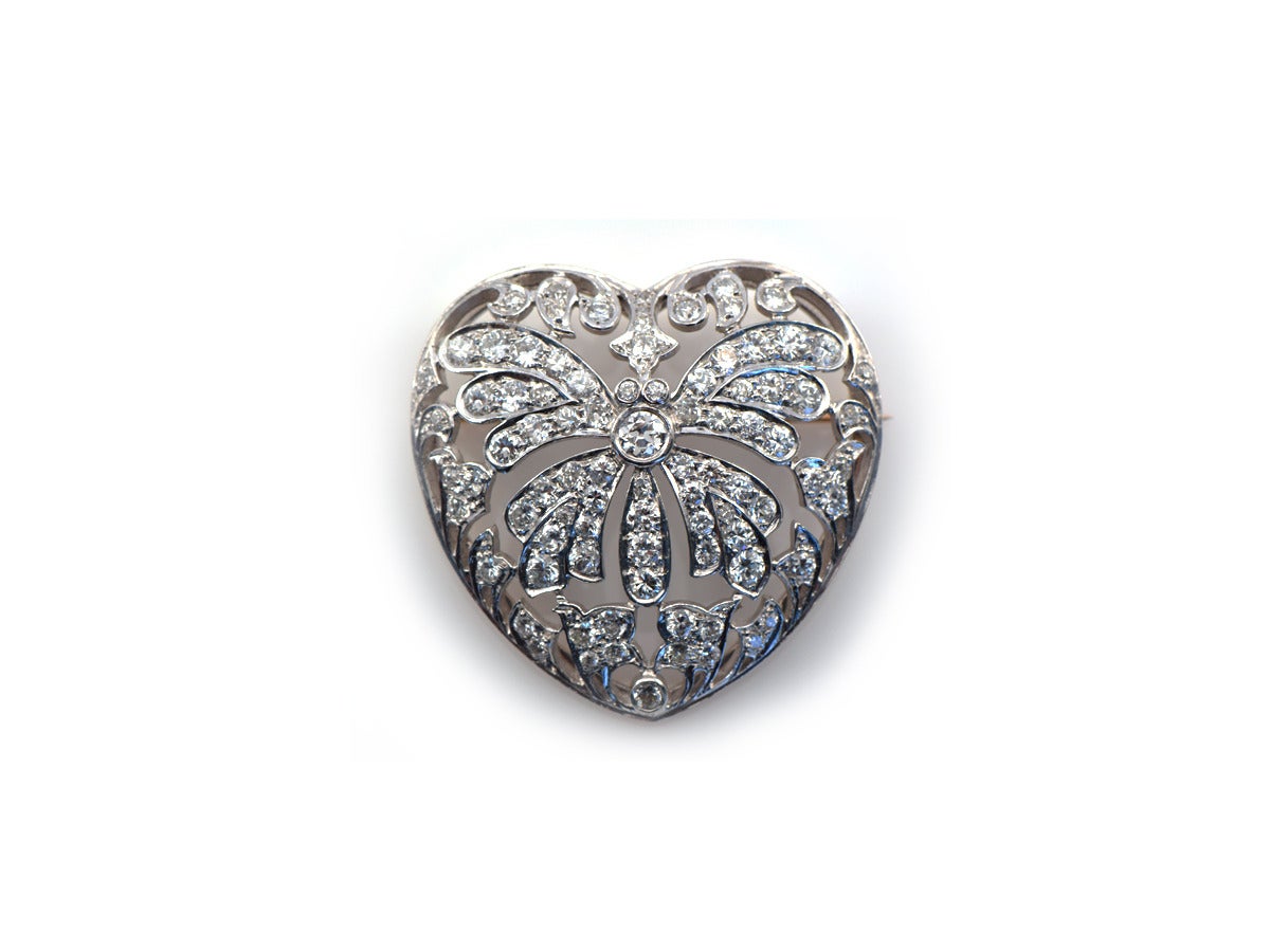 This sweetheart will make you melt! This diamond encrusted heart-shaped brooch sets 4.5 carats of modern and antique diamonds into platinum.  The back rim plate is in 14k yellow gold. 

*4.5cts of F/G color VS clarity diamonds
*there is a hidden
