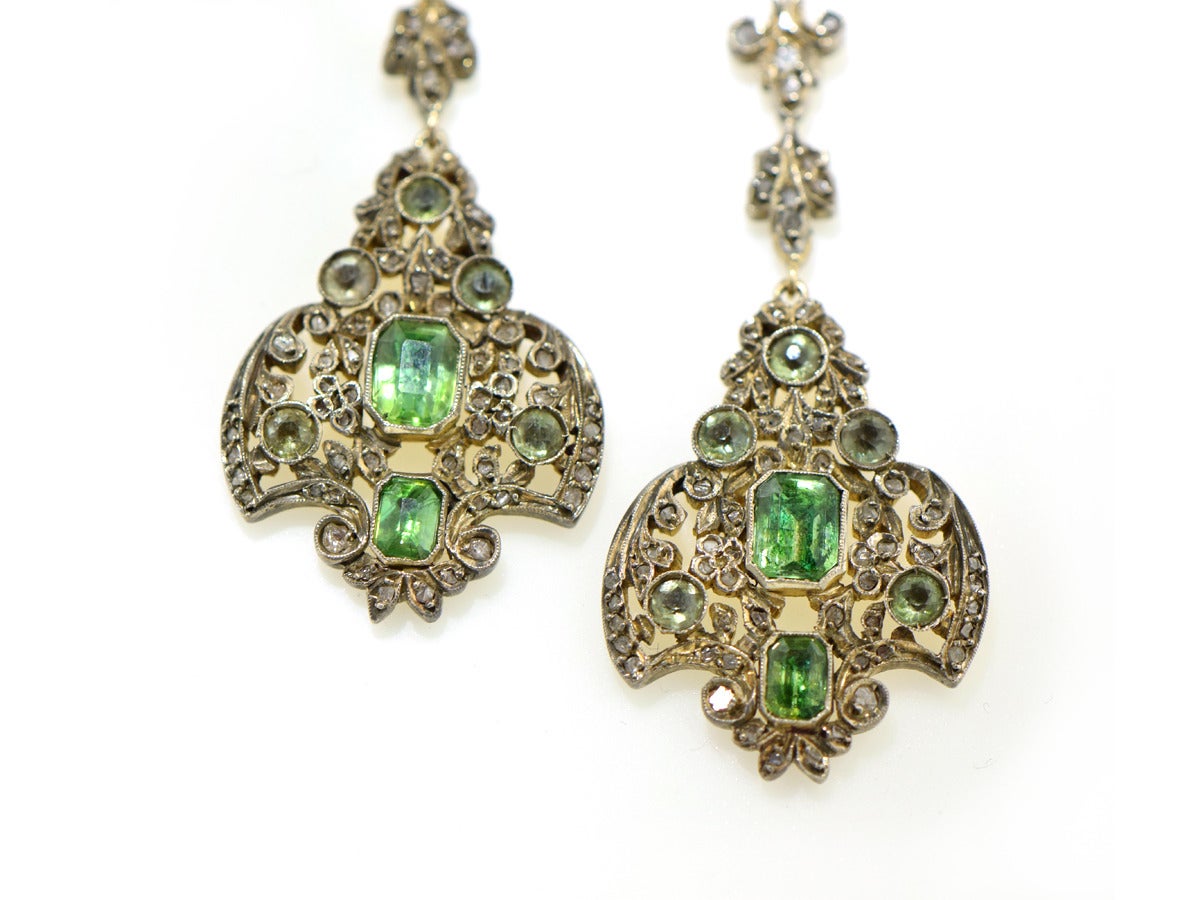 A pair of special, evening earrings created in patinated sterling silver and14k yellow gold setting green beryl stones.