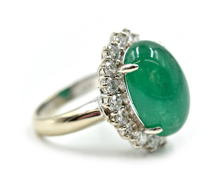 Designer: custom made
Gemstone: oval cabochon 10.33 carat emerald
Diamonds: 1.70 total carat weight
Color: G
Clarity: VS
Material: 14k white gold
Dimensions: top of the ring is 21.79mm in length and 17.78mm in width
Ring Size: ring size is currently
