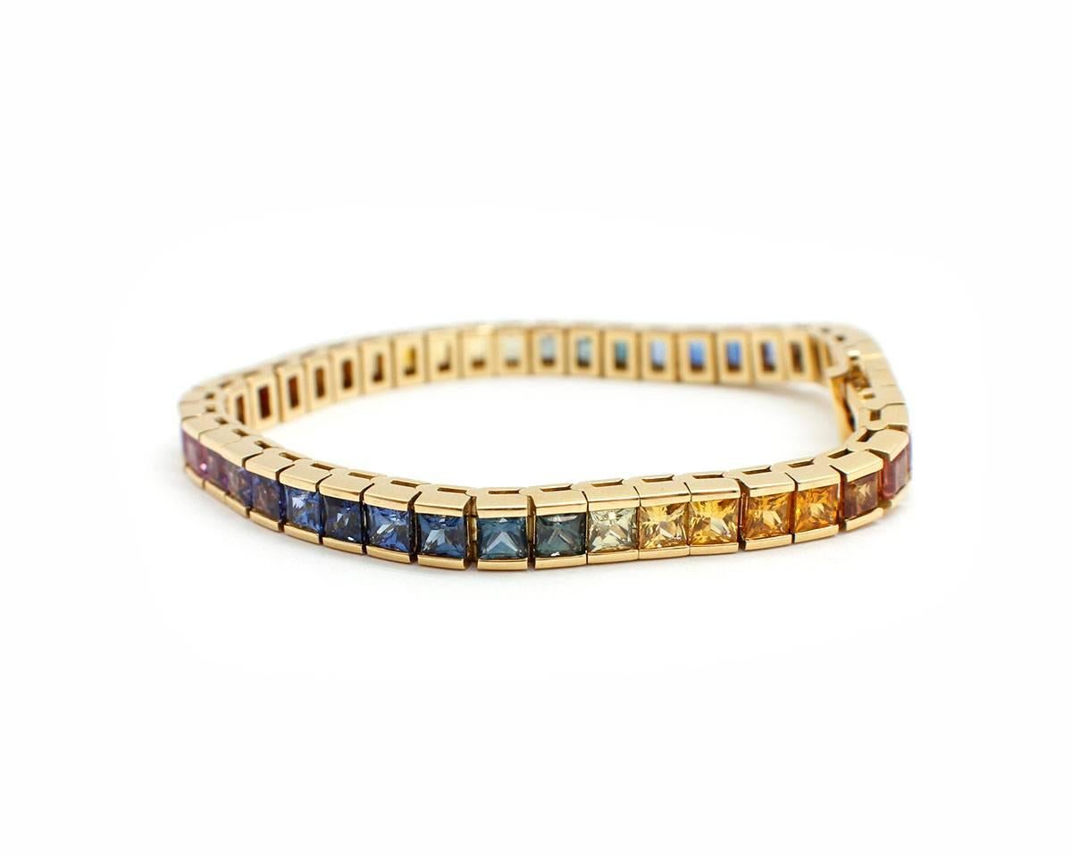 Designer: custom made
Material: 18k yellow gold
Gemstones: rainbow square cut sapphires, 15.73 total carat weight
Dimensions: 7 inch bracelet length, ¼ inch width
Weight: 34.3 grams


