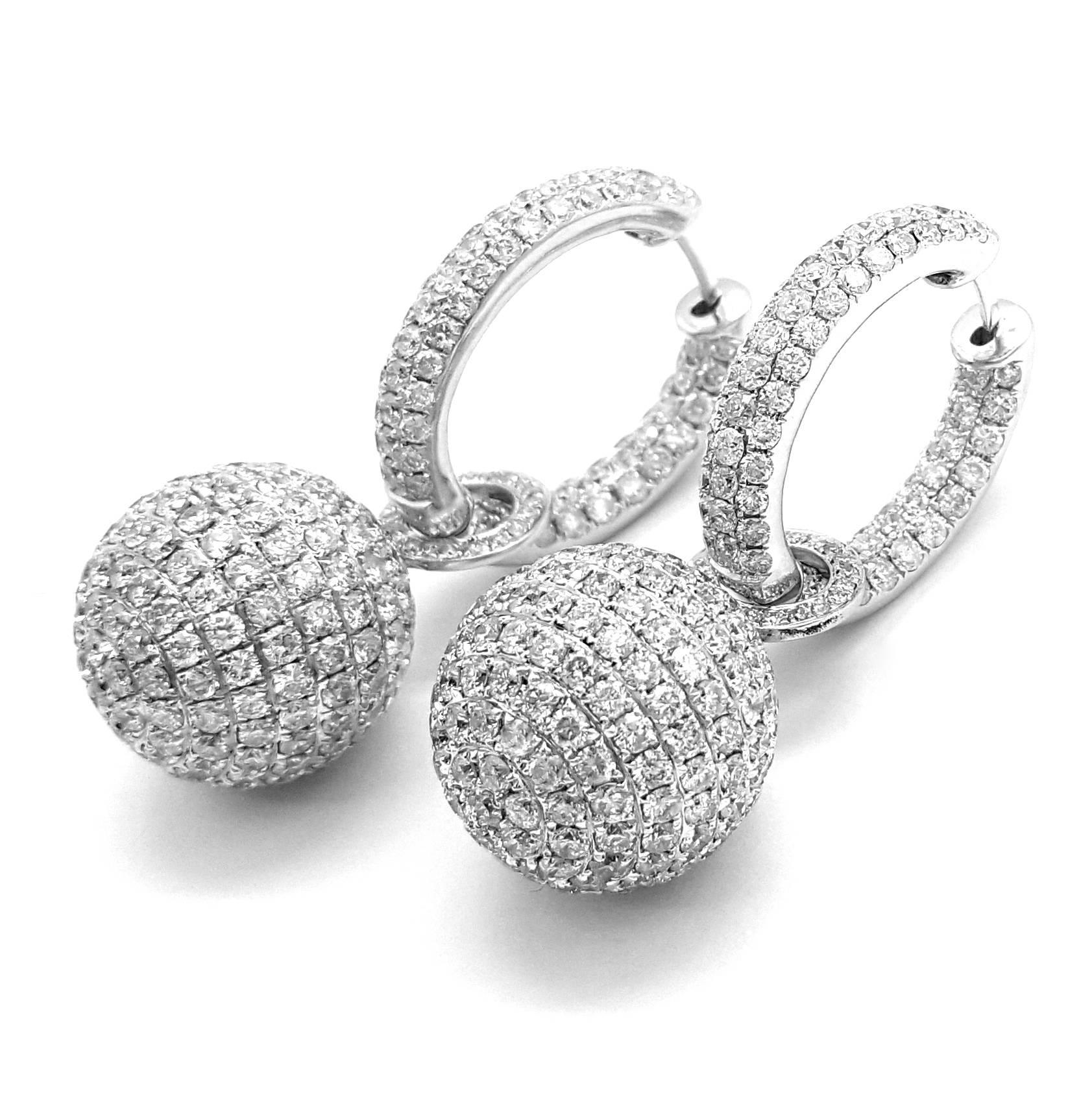 This is the real thing! These beautiful inside/outside diamond hoop earrings are crafted in 18k white gold. The earrings are pave set in three rows with 77 round brilliant cut diamonds each, for a total weight of 3.30cts. The stunning earring