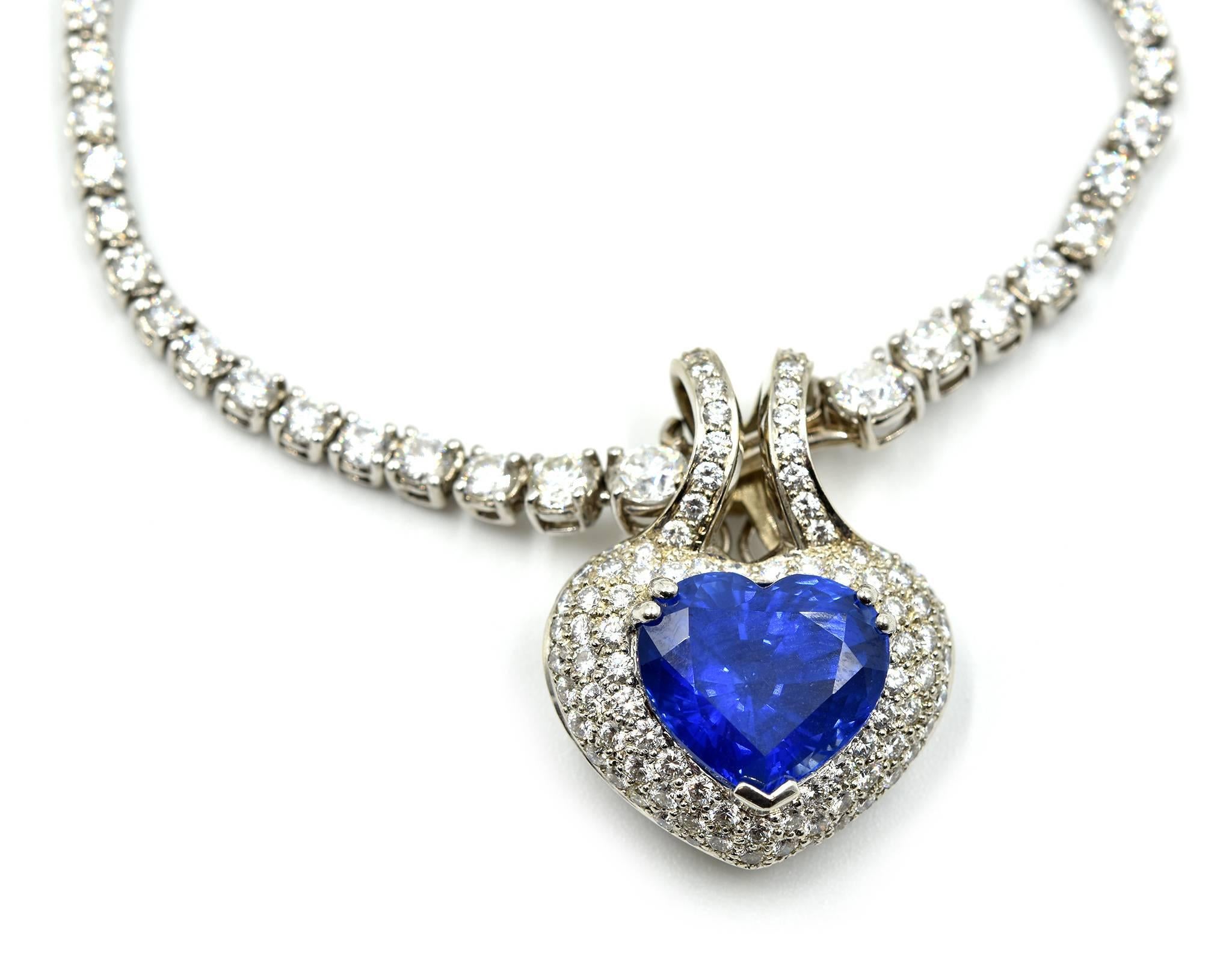 This necklace is breathtaking! A 13.50ct heart-cut sapphire sits in the center of an 18k white gold and diamond chain. The diamonds have an additional weight of 9.92 carats! The diamonds are graded G in color and VS in clarity. The pendant measures