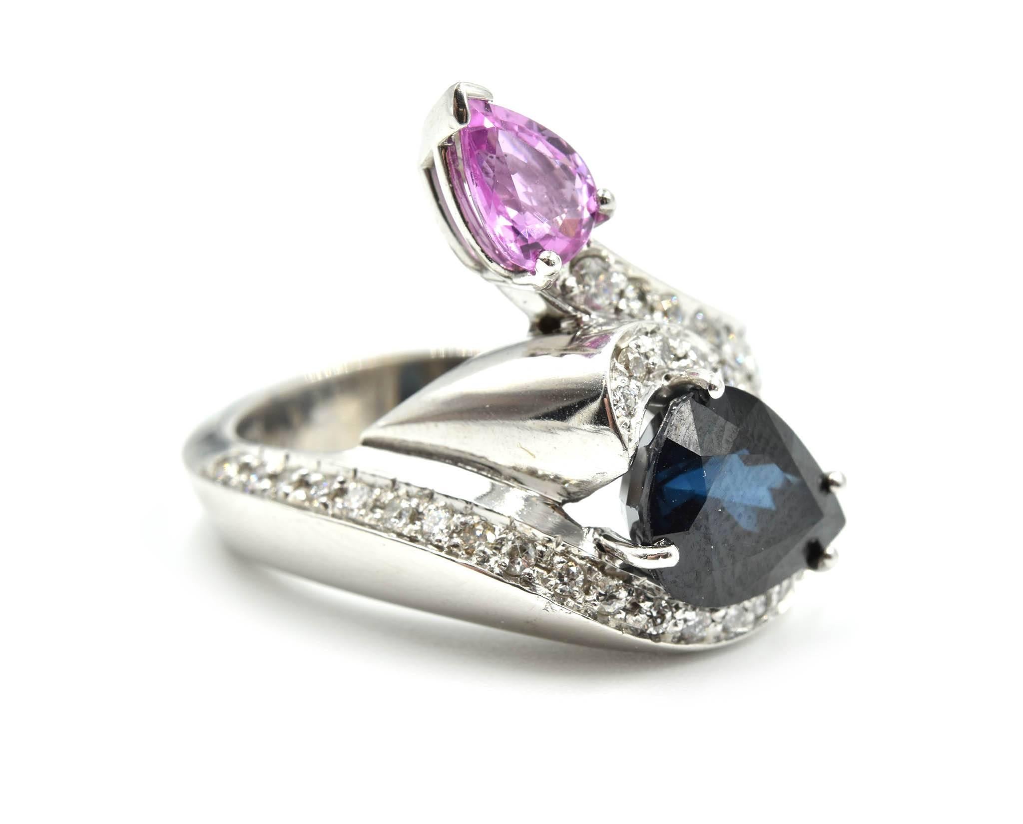 You do not see this every day!! This cocktail ring consists of 14k white gold, pear cut blue and pink sapphires, with a starry diamond mounting! The pear shaped blue sapphire weighs 3.32 carats and the pink sapphire 0.81 weighs 0.81 carats. The