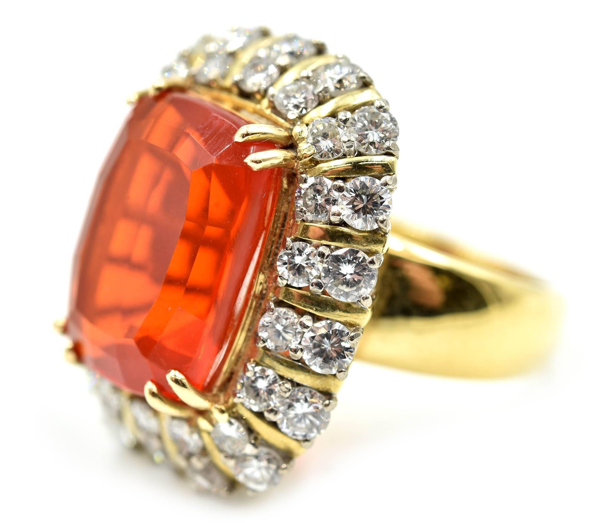 Designer: custom design
Material: 14k yellow gold
Mexican Fire Opal: cushion cut 6.64 carat
Diamonds: round brilliant 2.70 carat total weight
Color: H
Clarity: VS-SI
Dimensions: top of the ring is 20mm long x 23.74mm in height
Weight: 75.90 grams
