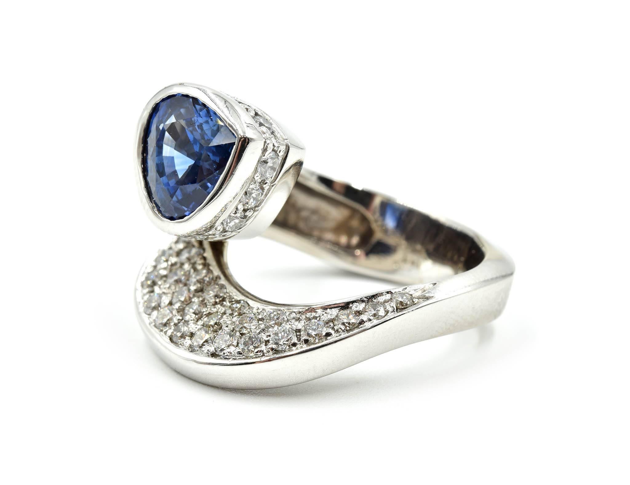 Designer: custom design
Material: 14k white gold
Sapphire: blue trilliant cut sapphire 4.19 carat weight
Diamonds: 1.18 carat total weight
Dimensions: 21.99mm in length and 19.32mm wide
Ring Size: 7 ½ 
Weight: 20.80 grams
