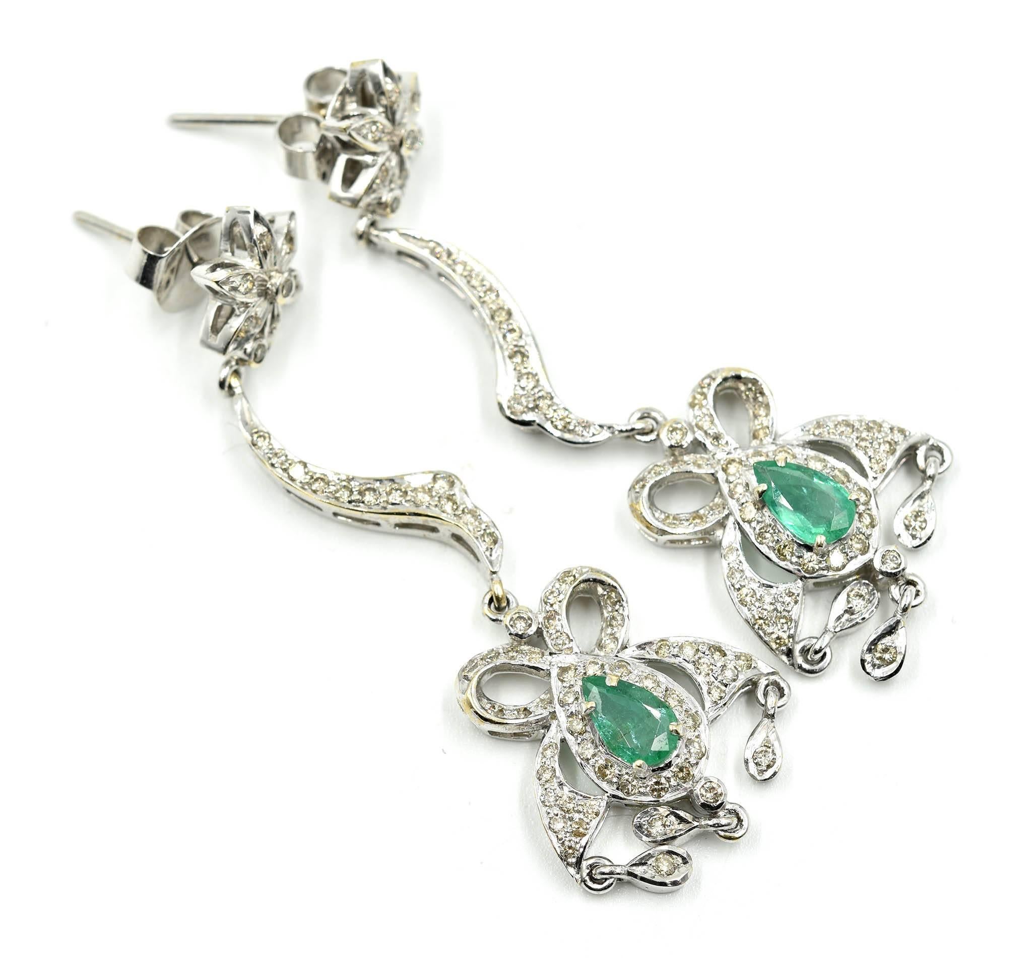 Designer: custom design
Material: 18k white gold
Diamonds: 1.60 carat total weight
Emeralds: two pear cut emeralds = 0.80 carat total weight
Dimensions: earrings dangle 2 ¼ inches x ¾ inches wide
Fastenings: friction backs
Weight: 16.80 grams
