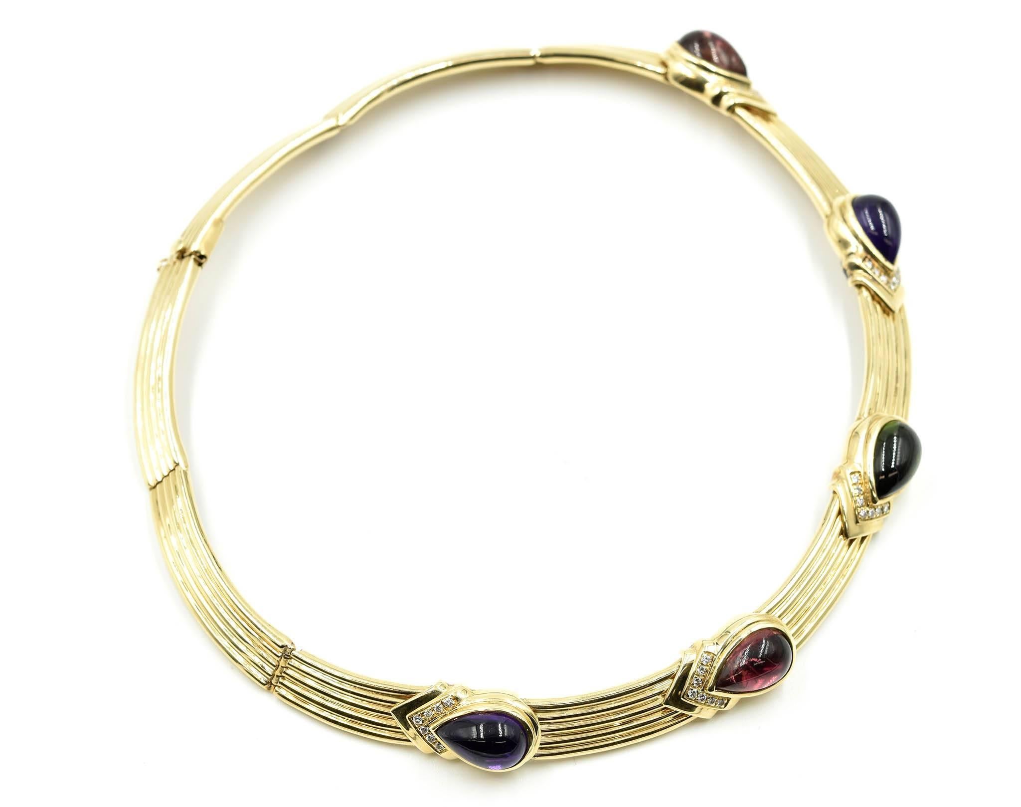 This bold and colorful neck collar is made in 14k yellow gold. There are five pear-shaped cabochon cut gemstones bezel set in stations at the front of the collar. At the point end of each setting is a chevron set line of 7 diamond melee. There are