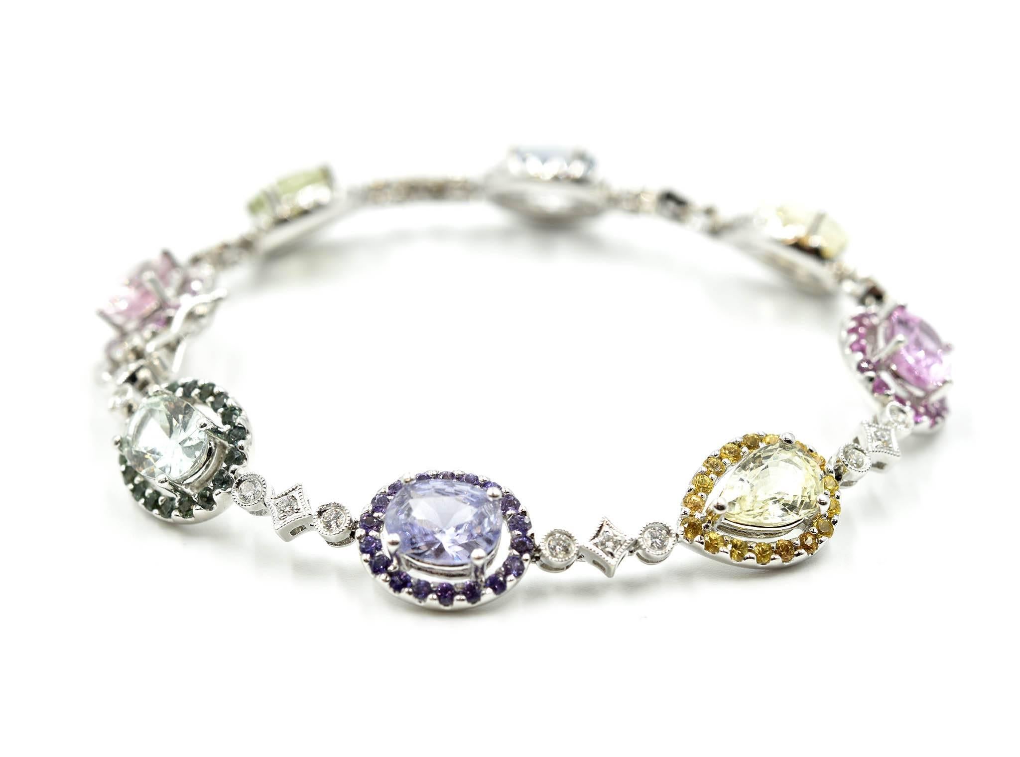 Designer: custom design
Material: 18k white gold
Diamonds: round brilliant cuts 0.47 carat total weight
Sapphires: round and pear cut sapphires ranging from yellow to pink to blue and green = 15.07 carat total weight
Dimensions: bracelet is 6 ¾