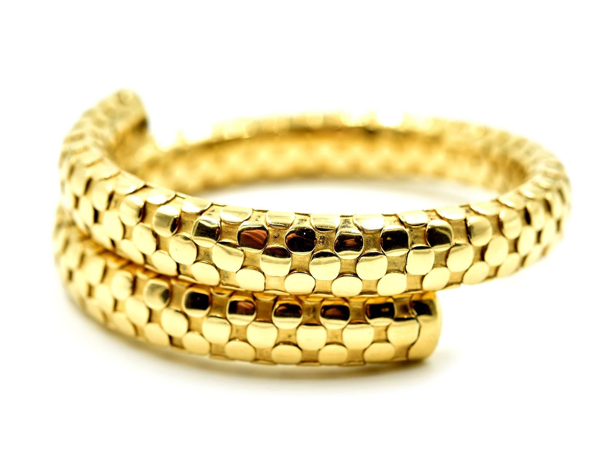 Designer: John Hardy
Collection: Dot Collection
Material: 18k yellow gold
Dimensions: bracelet opens up to 7 inches and is 3/8 an inch wide, top of the bangle where is ¾ an inch wide
Weight: 60.34 grams
