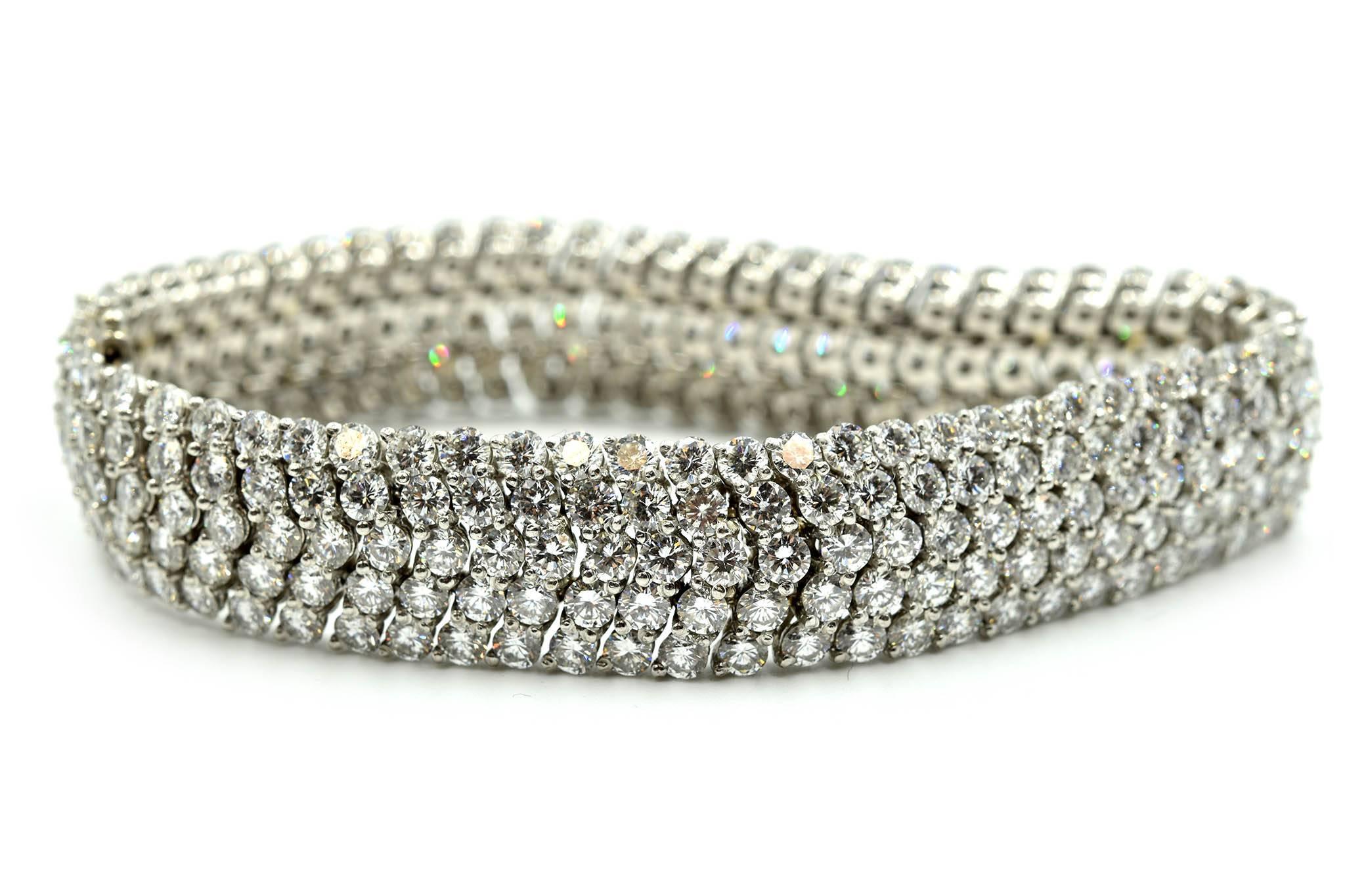 This bracelet scintillates like stars. The round diamonds weigh 30.00 carats. The diamonds are graded G in color and VS in clarity. The bracelet measures 13.23mm in width and 7” inches in length. The diamond 18k white gold bracelet weighs 65.43