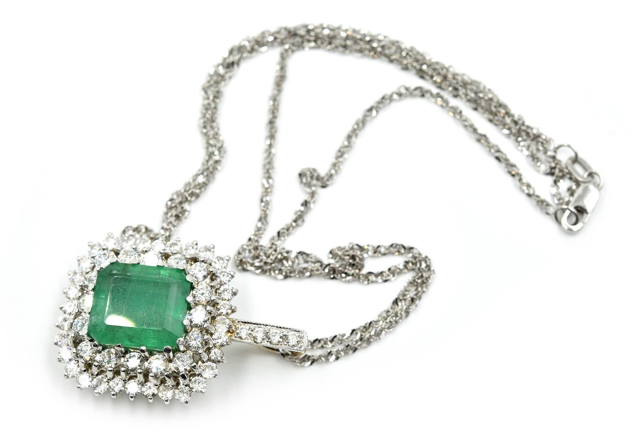 This ladies’ pendant consists of 3.00 carats of diamonds with a tremendous emerald set in the center! The diamonds form two halos around the emerald. The emerald weighs 7.10 carats. The pendant is designed in 14k white gold. The awe-inspiring