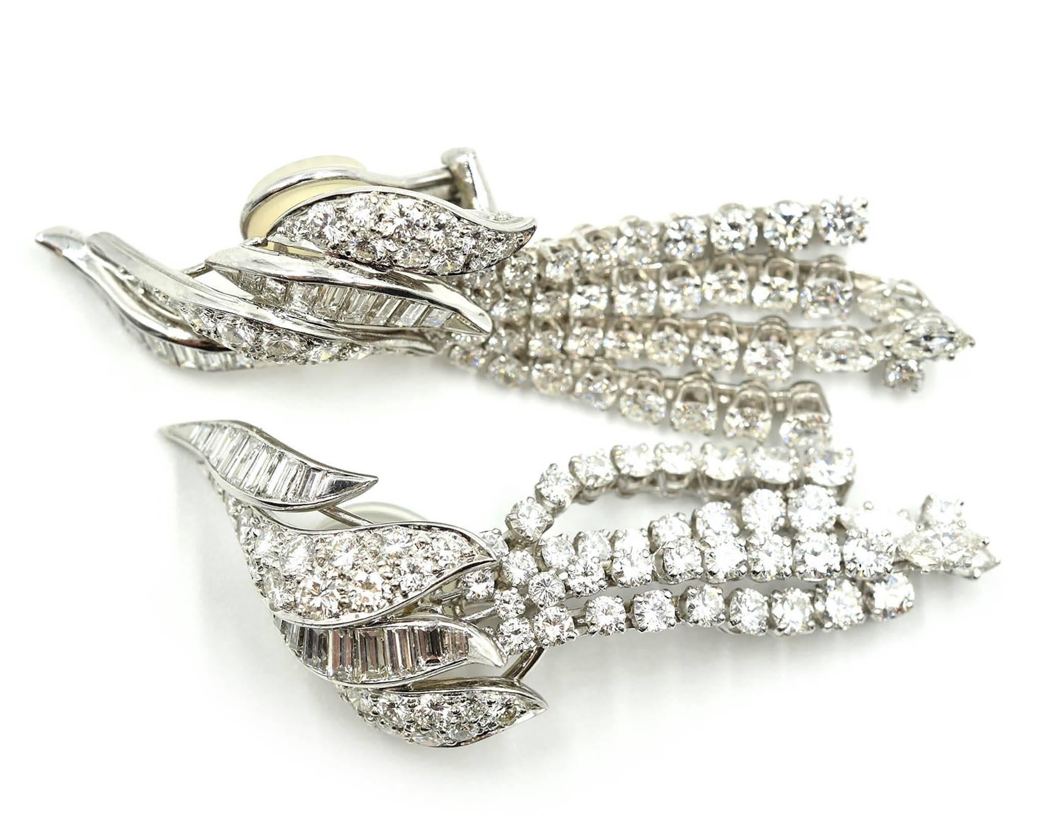 A creative and unique design by elite designer David Webb! These earrings feature 9.06 carats of round, baguette, and marquise diamonds set in platinum. The earrings are channel set with baguette diamonds and pave set with round brilliant diamonds