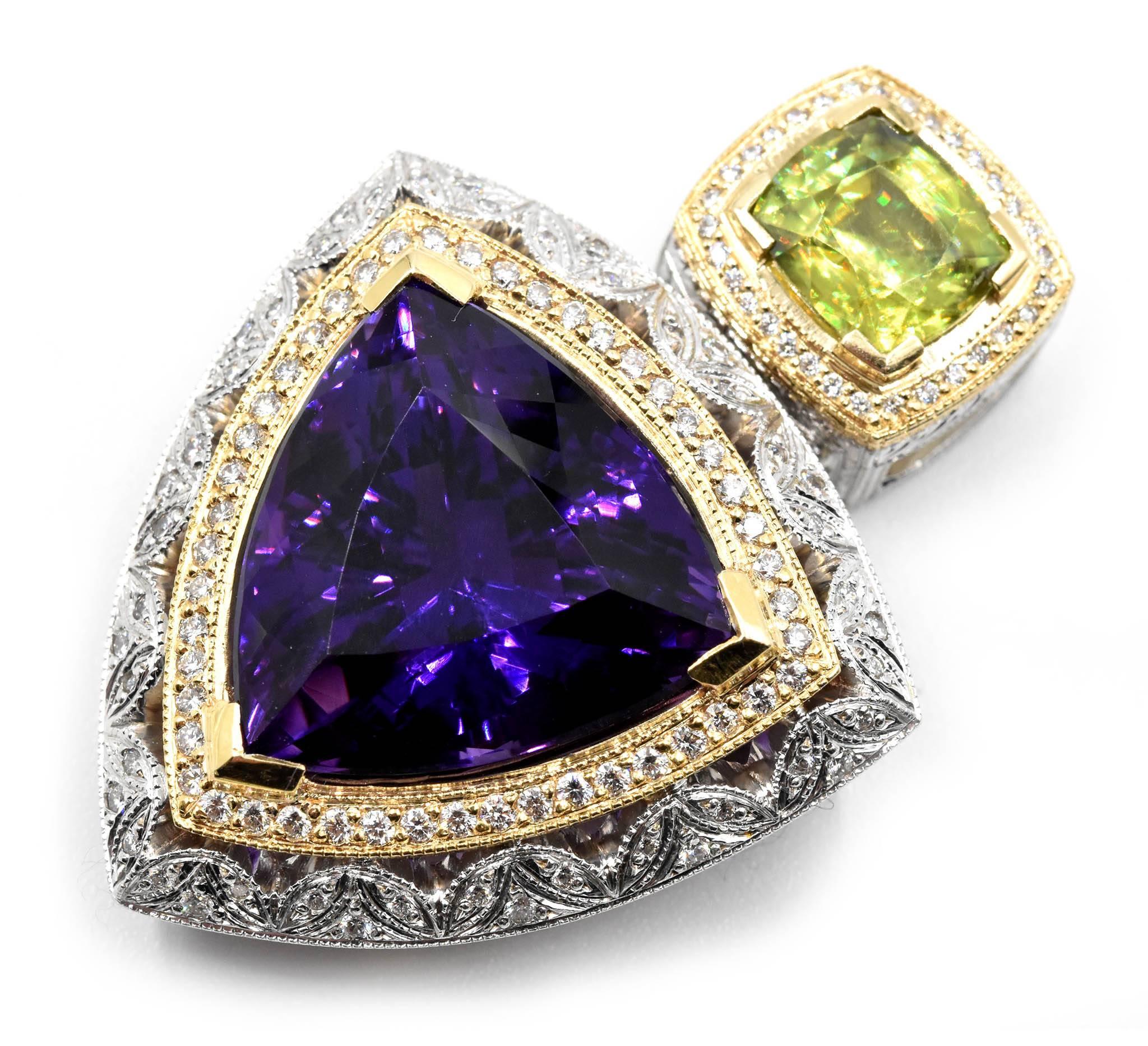 Designer: custom design
Material: 14k yellow and white gold
Amethyst: trilliant cut 21.20 carat weight amethyst 
Sphene: cushion cut 3.42 carat weight sphene
Diamonds: 128 round brilliants = 0.87 carat total weight
Dimensions: pendant measures 2 ¾