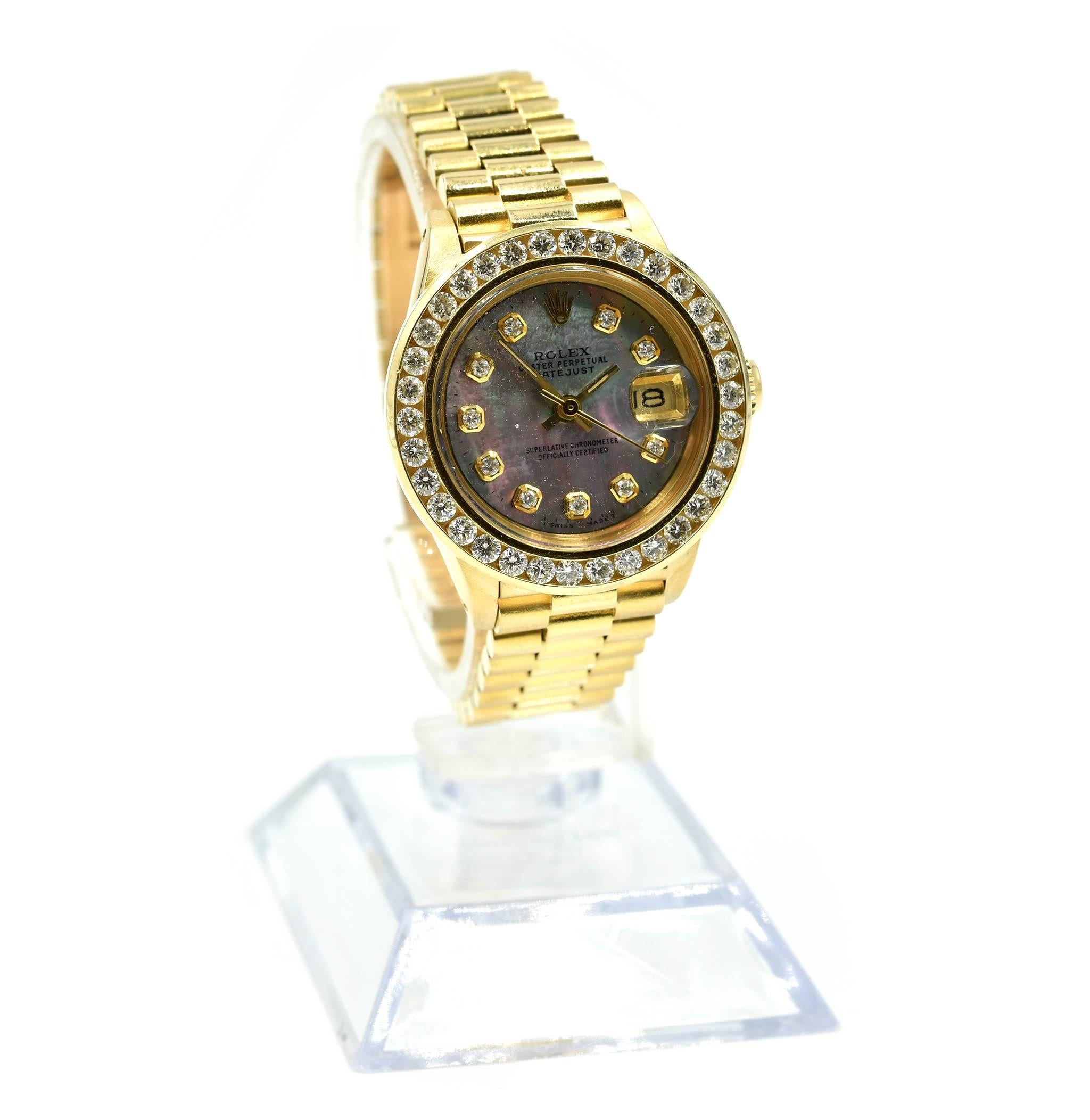 Movement: automatic
Function: hours, minutes, seconds, date
Case: round 26mm 18k yellow gold case with factory diamond bezel, screw-down crown, sapphire protective crystal, water resistant to 30 meters
Band: 18k yellow gold presidential bracelet