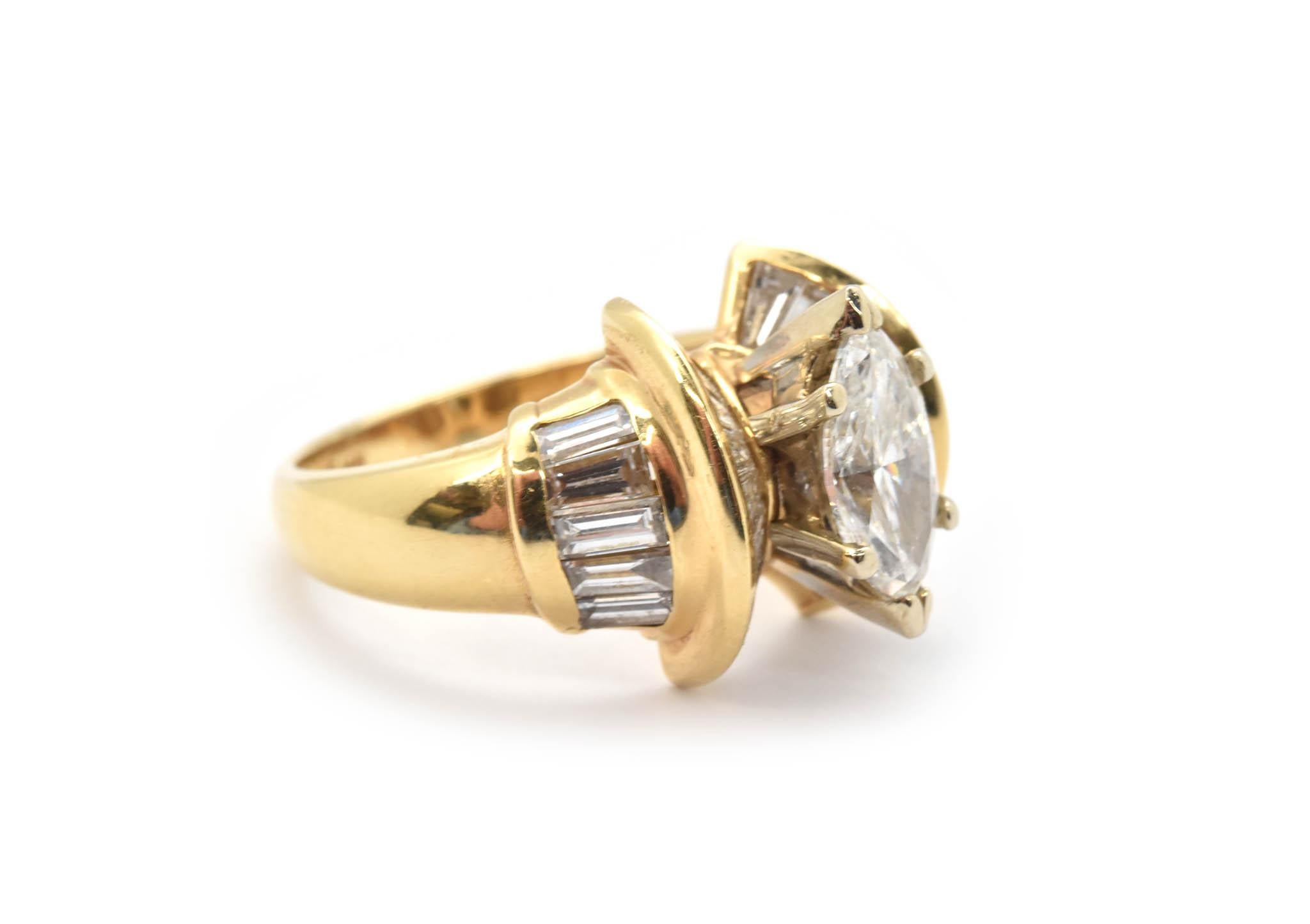 This ring is made in 14k yellow gold, and it holds an EGL-certified marquise-cut diamond. The center stone is graded F in color and SI2 in clarity. The marquise is decorated with an additional 1.60 carats in baguettes for ultimate sparkle. The ring