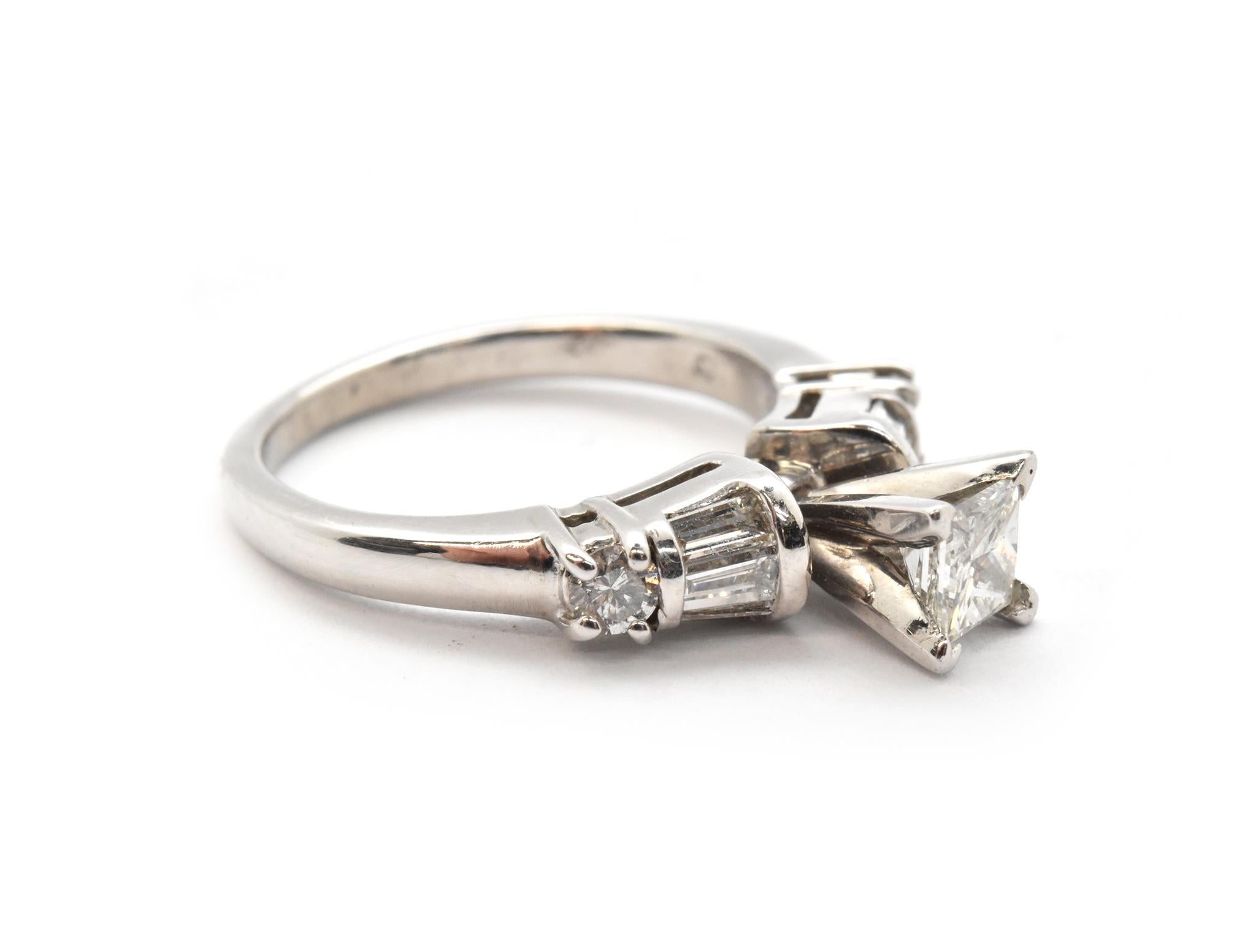 Designer: custom design
Material: platinum
Center Stone: princess cut 0.40 carat diamond
Color: H
Clarity: SI
Accent Diamonds: 0.24 carat weight
Total Carat Weight: 0.64 carat total weight
Ring Size: 8 1/2 
Dimensions: ring top is 4.37mm