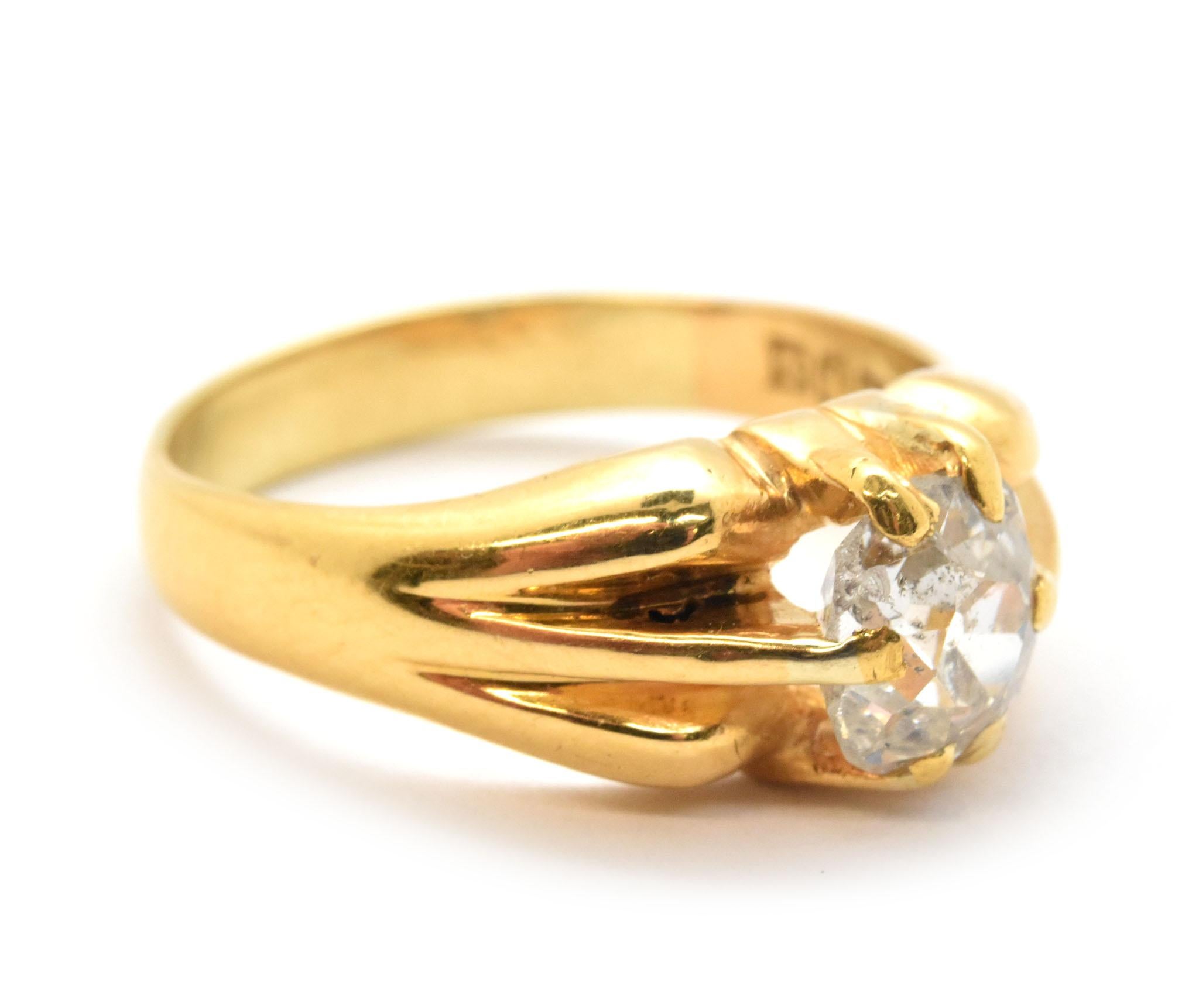 This beautiful ring is made in 21k yellow gold, and it features a 1.10-carat mine-cut diamond at its center. The diamond is graded H in color and SI2 in clarity. The ring measures 8mm wide, and it weighs 8.17 grams. It is a size 7.75.
