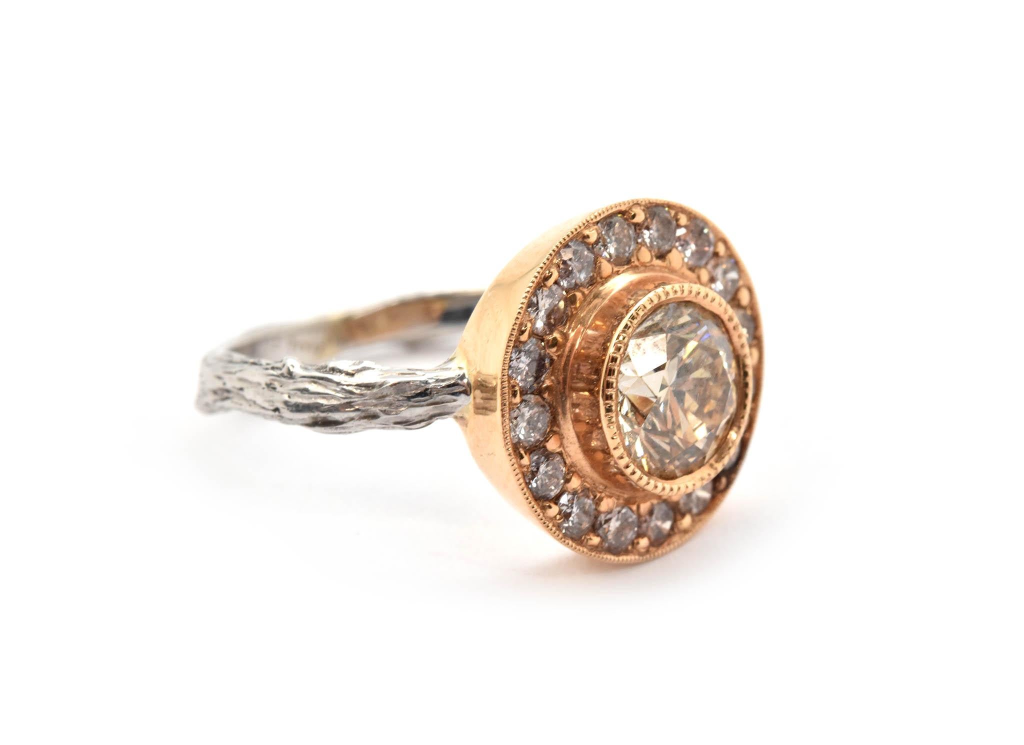 This gorgeous ring is made in 18k white and rose gold by K. Brunini for the Twig collection. The center diamond weighs approximately 1.10 carats, and it is graded champagne in color and VS1 in clarity. The center diamond is surrounded by a halo of