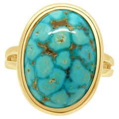 Anello solitario con turchese taglio cabochon ovale incastonato a castone in oro giallo 14 carati
