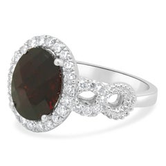 Platinum Oval Checkerboard Cut Garnet and Round Diamond Halo Ring
