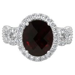 Platinum Oval Checkerboard Cut Garnet and Round Diamond Halo Ring