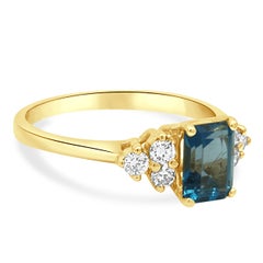 14K Yellow Gold Prong Set Emerald Cut Blue Topaz and Round Diamond Accent Ring