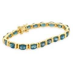 14K Yellow Gold Faceted Oval Cut Blue Topaz Inline Bracelet 7.0"
