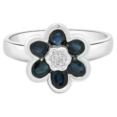 14 Karat White Gold Oval Cut Blue Sapphire and Round Diamond Flower Ring