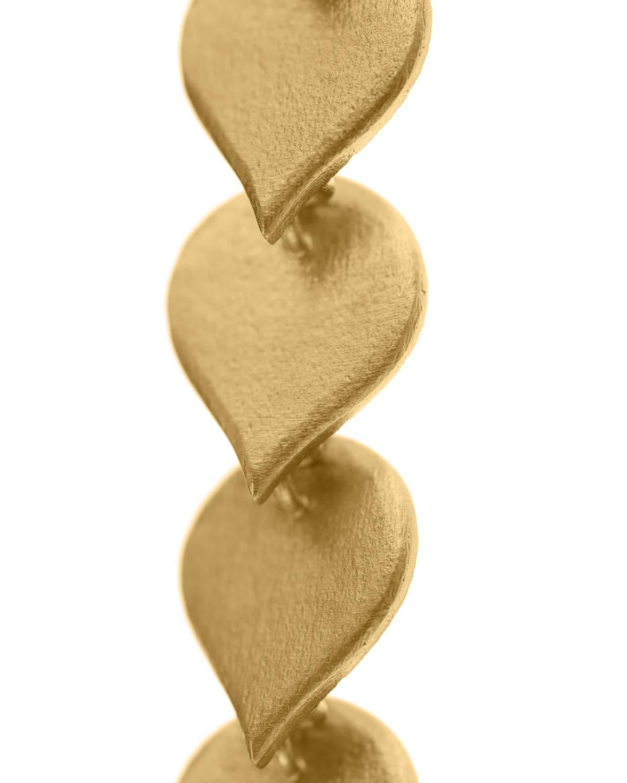 Timeless 18k-gold plated brass earrings for all ages featuring drop shaped motifs linked to each other. The drop that touches the ear is sterling silver gold plated and the earring posts 10k gold to avoid allergies. The rest of the earring is gold