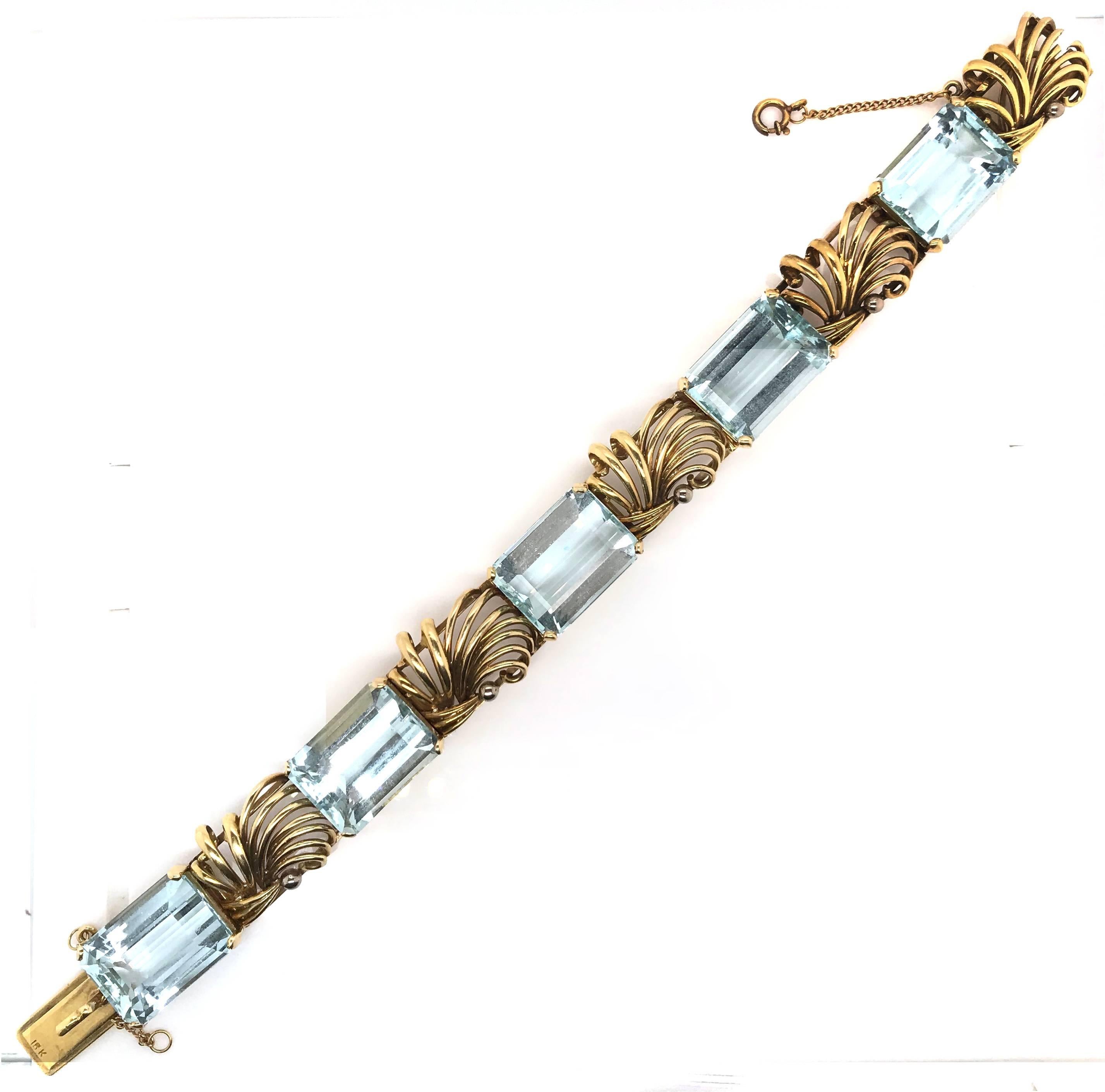 Featuring a Yellow Gold Vintage Retro Bracelet of alternating swirl wire links wide and claw set with 5 Emerald Cut Aquamarines. Each Aquamarine is 13 Carats.

Estimated Total Aquamarine weight - 65 Carats
Total Weight of the piece - 54 Grams