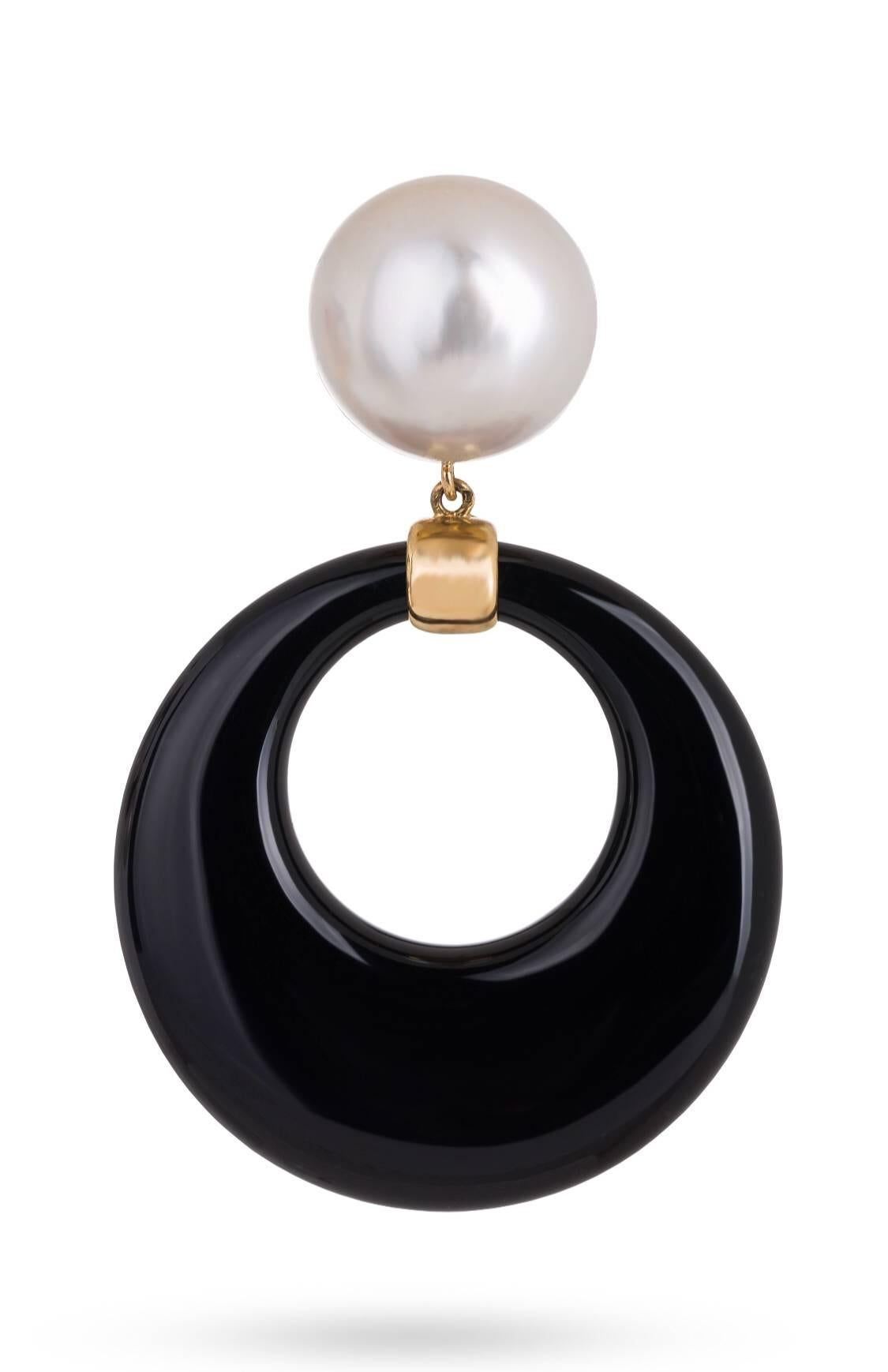 Long, but not too heavy, except in their impact 18K Yellow Gold Earrings. Each Earring has an open free floating Onyx drop rings. The top of each Earring has a Mabe Pearl Set in Gold.
The Earrings are post back with lots of movement on the Ear.