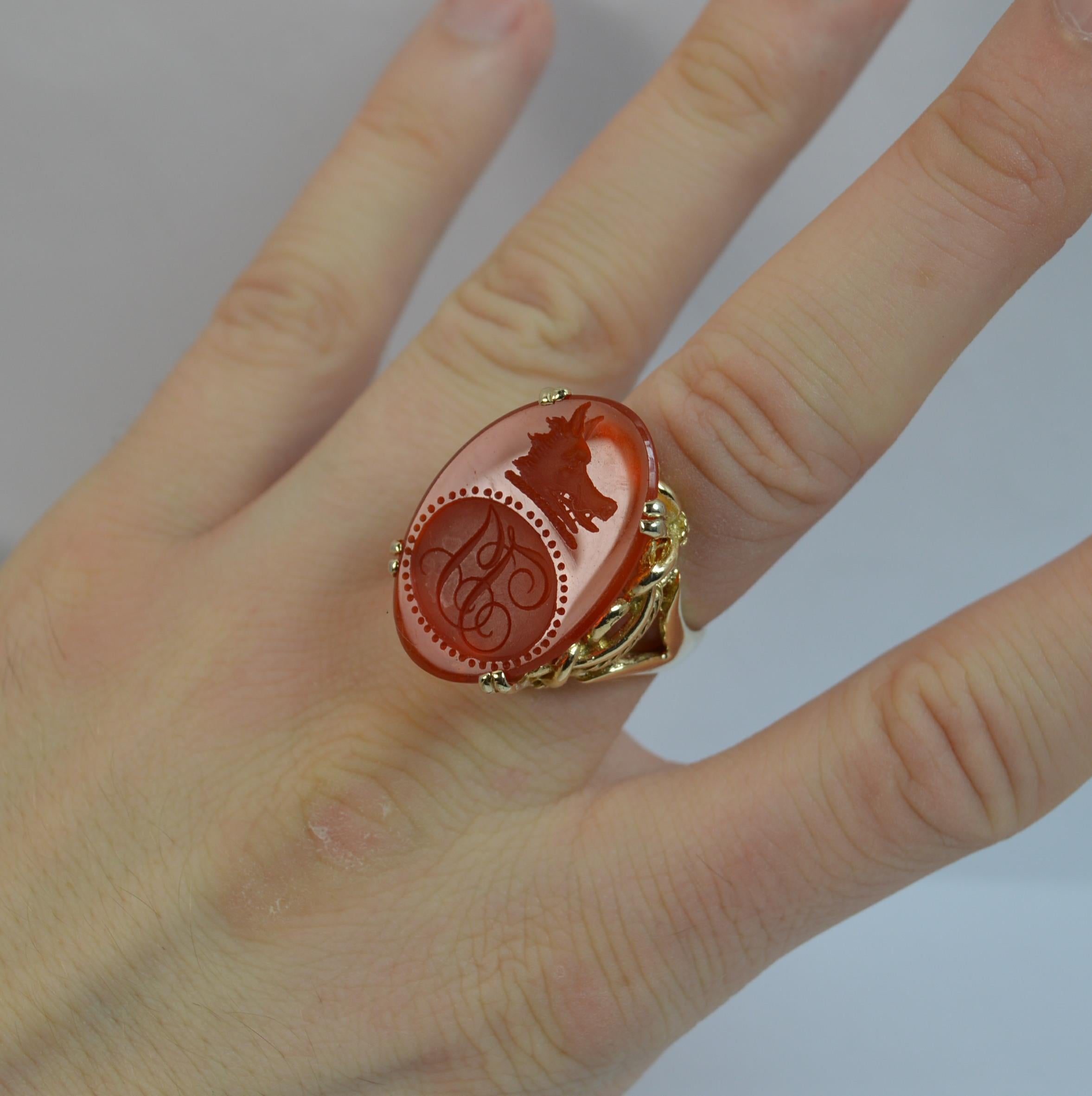 
A stunning 9 carat gold and carnelian ring.

18mm x 27mm oval or navette shaped carnelian with intaglio seal engraved. The design is of a wild boar head above a cartouche with two initials engraved.

The intaglio of Georgian era set into a