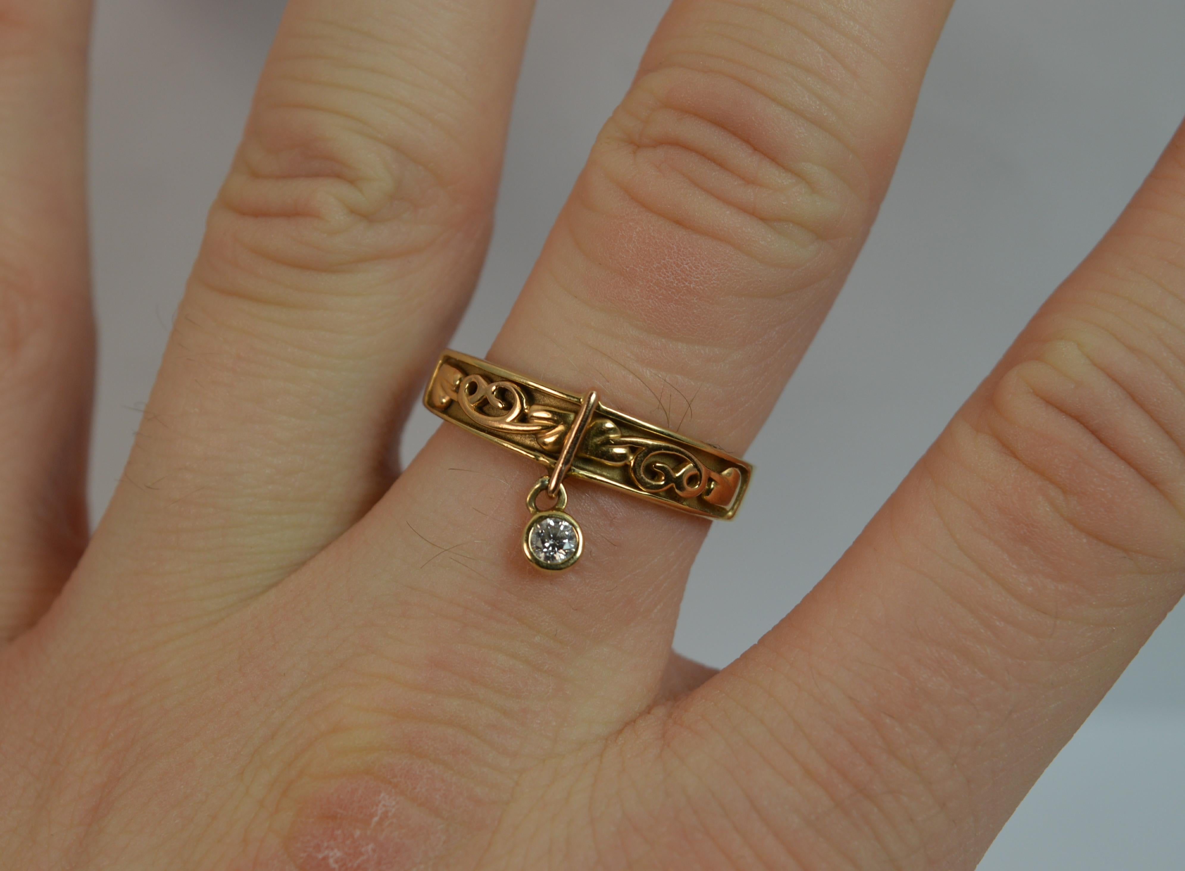 
A rare ladies CLOGAU Welsh Gold band ring.

Solid 18 carat yellow gold band with a rose gold tree of life design to the front and diamond drop.

​The lnatural round brilliant cut diamond dangles off in a collet setting. 3.1mm diameter.

The design