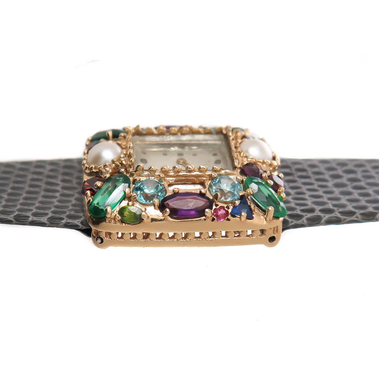 Lucien Piccard lady's 14K yellow gold wristwatch, circa 1950s, set with pearls, garnets, zircons, amethyst and other semi-precious stones. Manual-wind movement. Case measures 1 1/8 X 1. New lizard strap and original 14K Lucien Piccard buckle.
