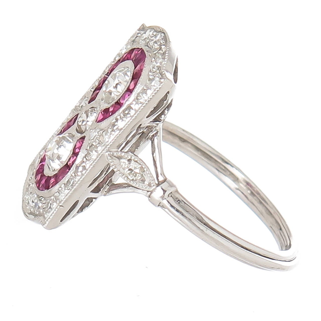 Circa 1930s Platinum Diamond and Ruby Ring, European cut Diamonds totaling approximately 1 Carat with two circles of fine color Swiss Cut Rubies. Finger size = 6