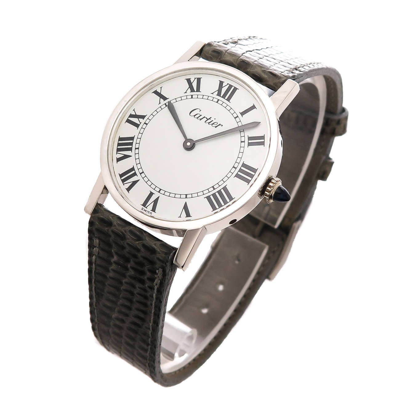 Circa 1970s Cartier wristwatch in a 31 M.M. Calatrava style case. Manual wind 17 Jewel Cartier movement, white dial, black Roman numerals, sapphire crown. Gray lizard strap with silver Cartier buckle.