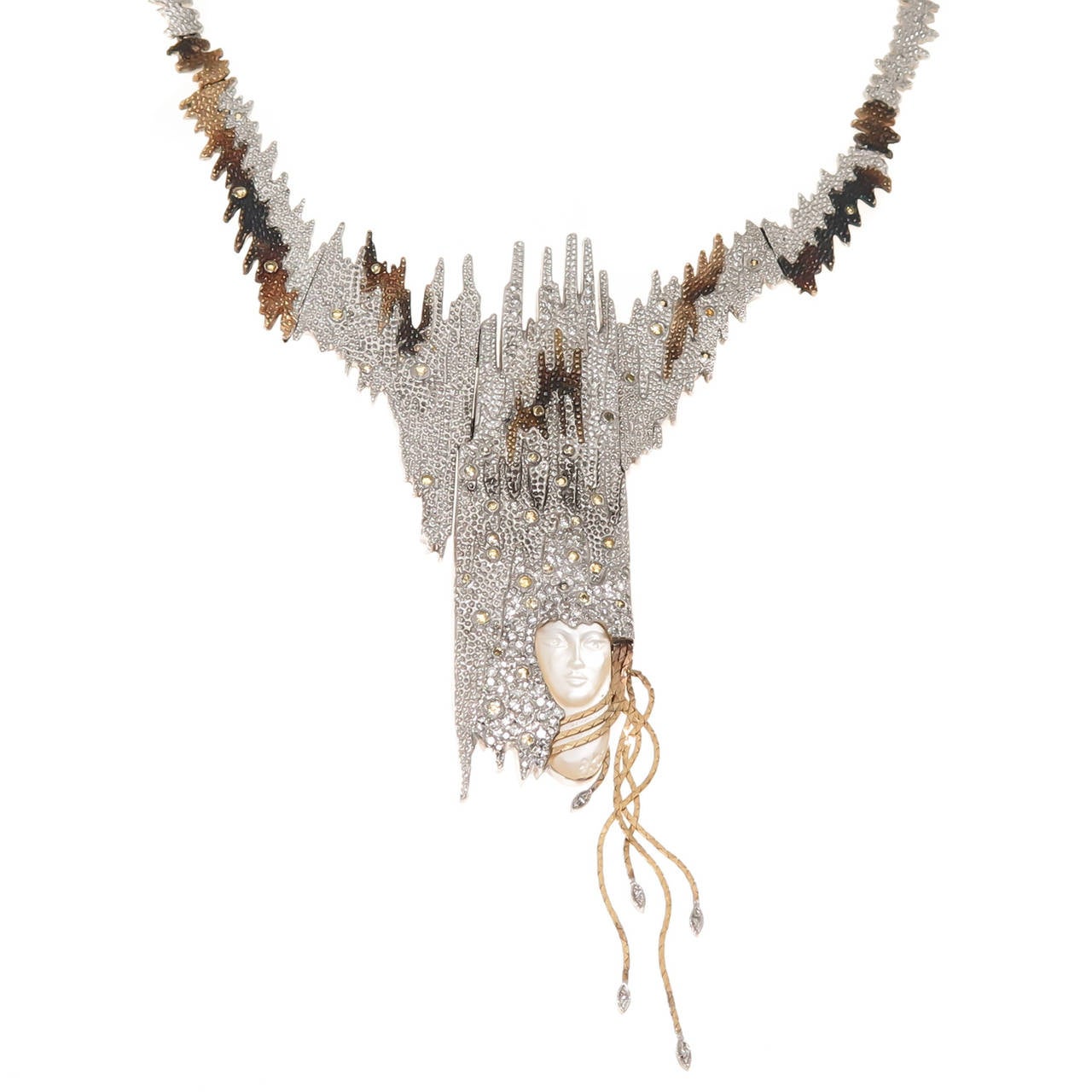 Circa 1984 Sophistication Necklace by Erte, 14K Yellow Gold and Sterling Silver, Finely textured and having Granulation work throughout, set with Numerous Diamonds and a Carved Face of Mother Of Pearl. This Piece converts into a large Brooch and a