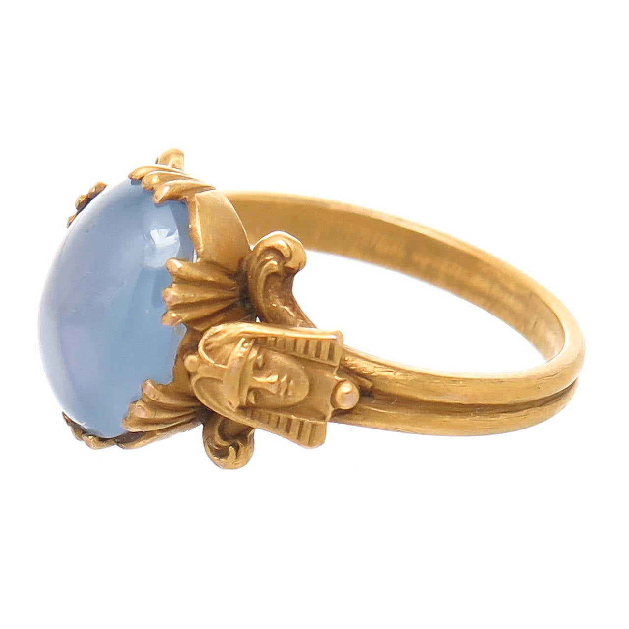 Circa 1910 14K Yellow Gold Egyptian Revival Ring, set with a Light Blue Star Sapphire measuring 9.5 X 7  approximately 2.5 Carats. Signed 